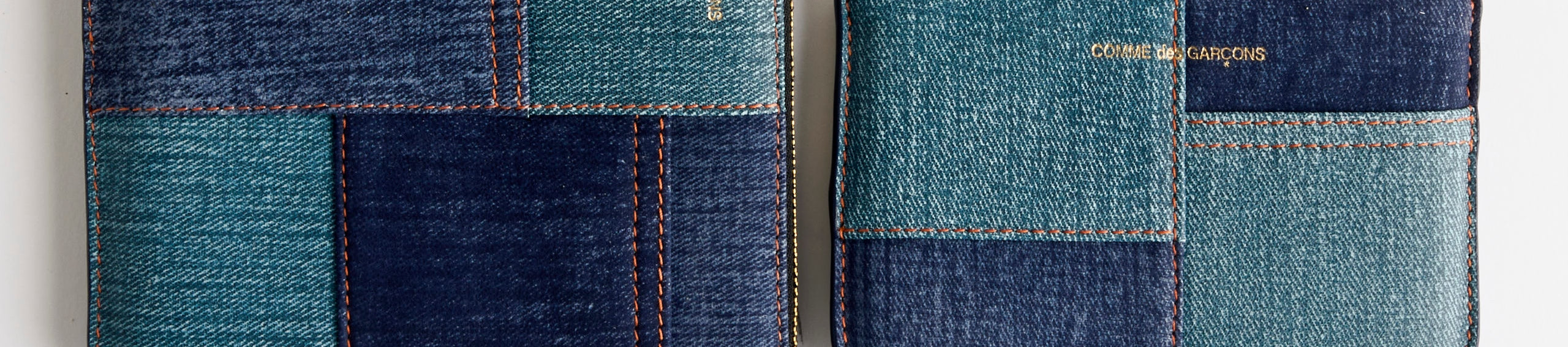 A display of men’s accessories, including a brown cap, a black crossbody bag, a black belt, black leather loafers, brown hiking boots, brown gloves, a gray beret, and a dark red sock.