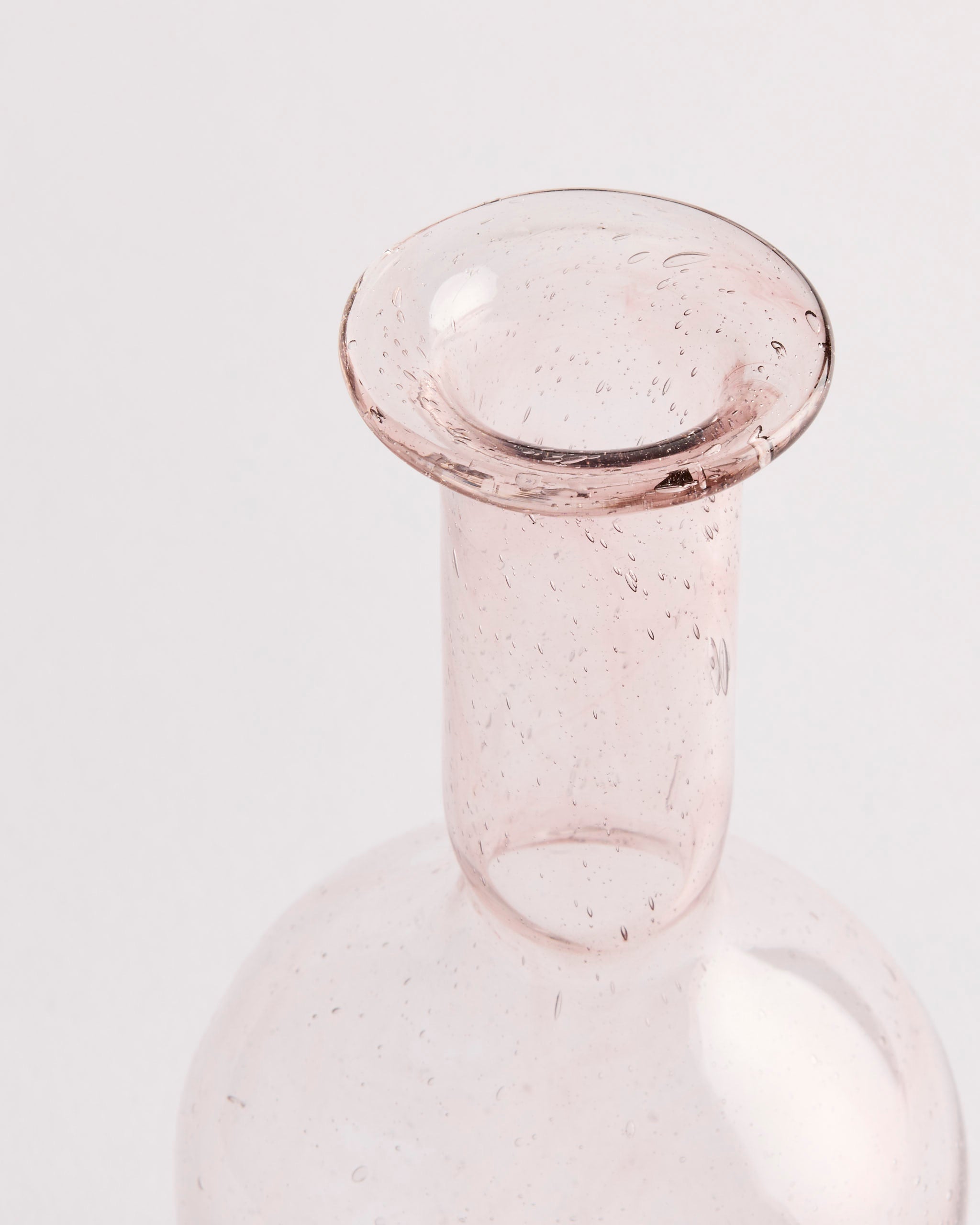 A close-up of the neck and rim of the Capelli Vase in Transparent by La Soufflerie, featuring hand-blown recycled glass with small embedded air bubbles, set against a plain white background.