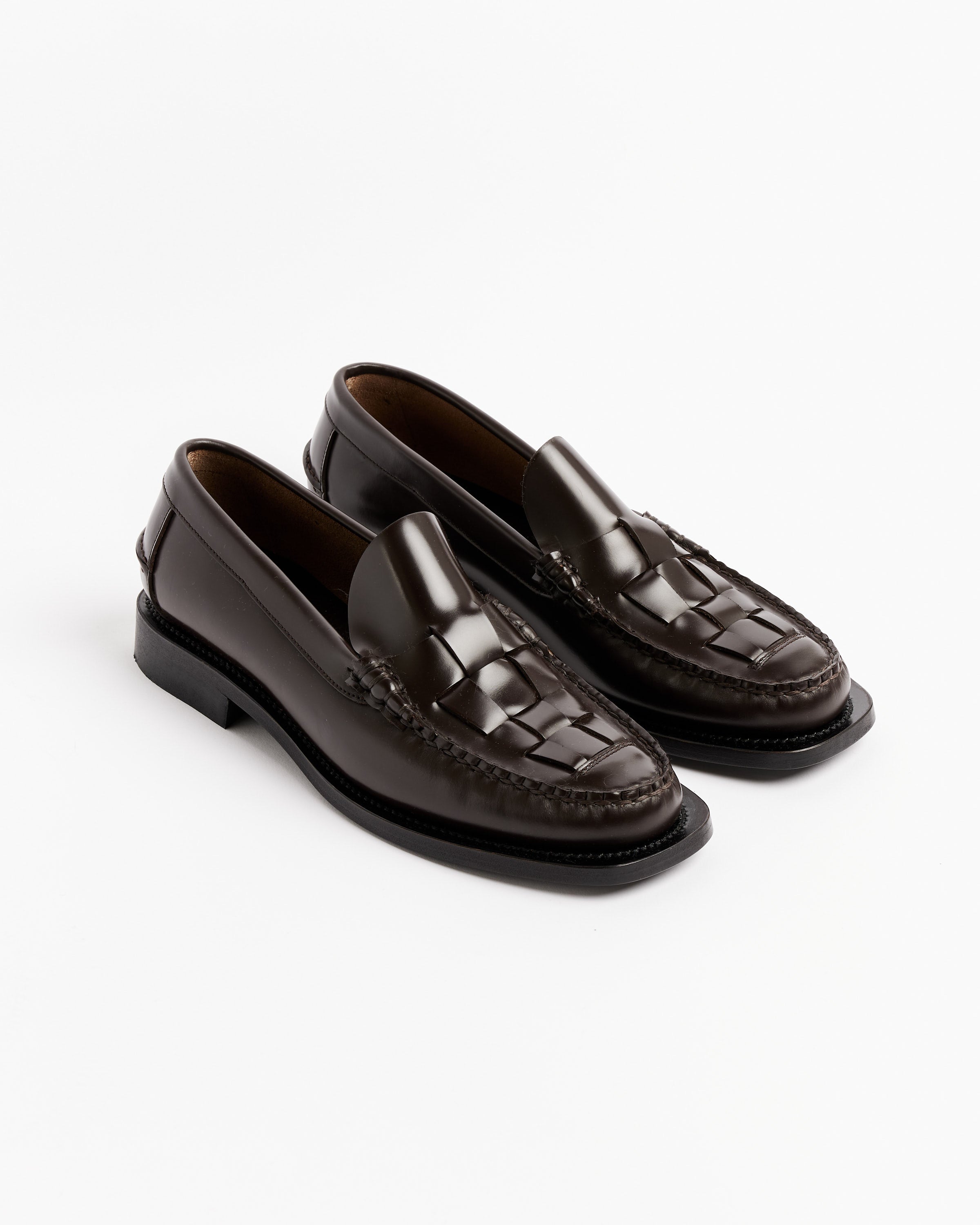 The Nombela Loafer in Dark Brown by Hereu features handmade Spanish craftsmanship and woven front detailing, presented on a plain white background.