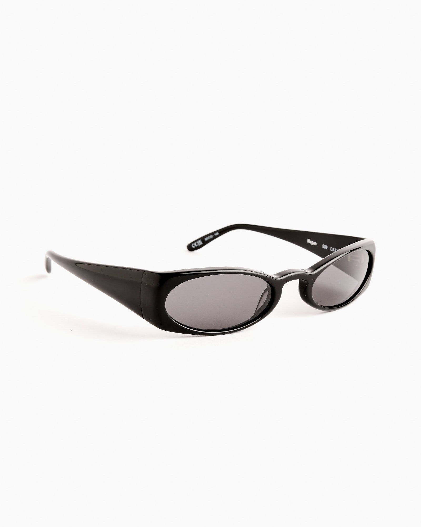 Henrik Vibskov Megan Sunglasses in Black feature thick black oval acetate frames and dark tinted lenses. Shown on a plain white background with the arms slightly open.