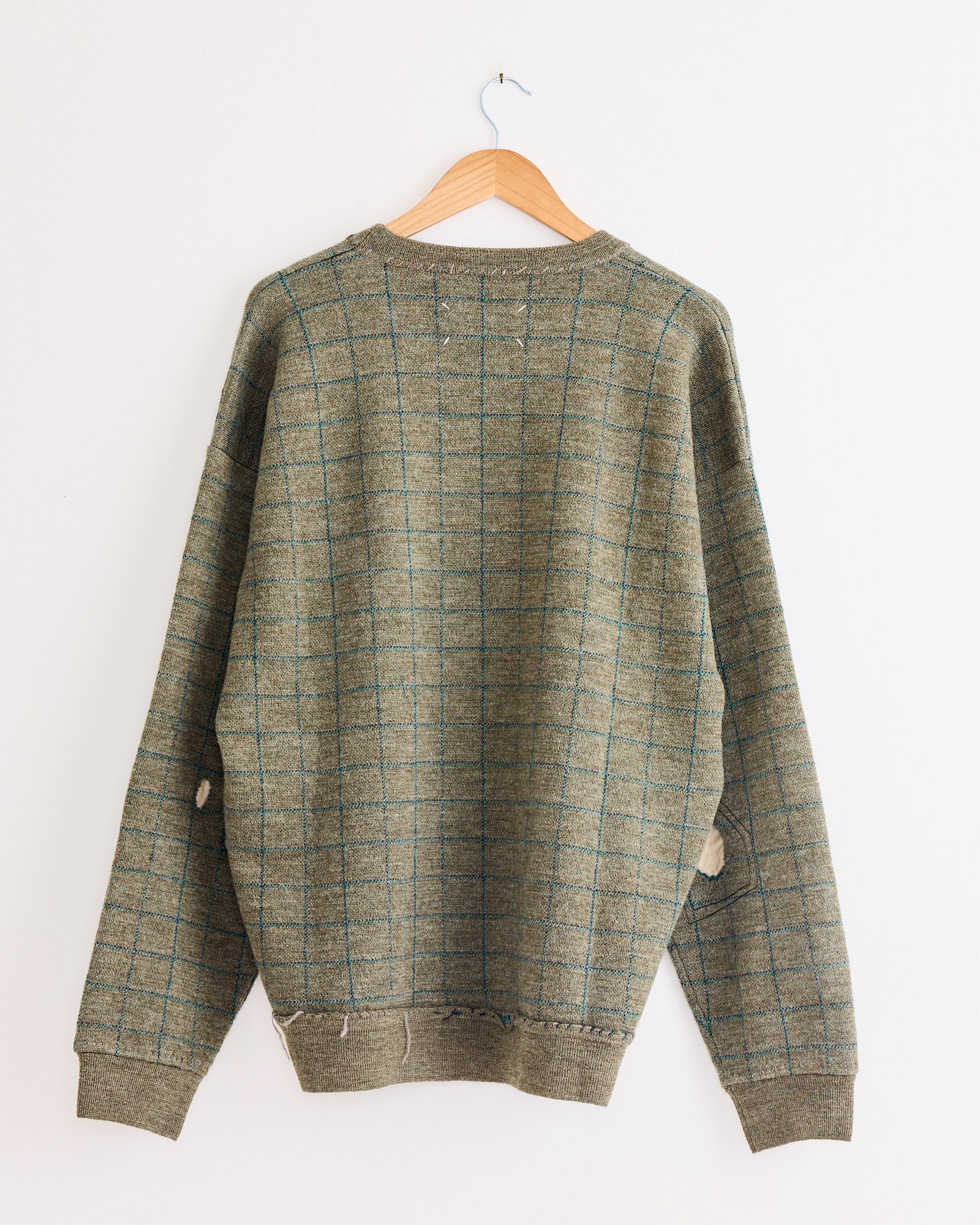 A Maison Margiela Crewneck in Green on a swinger.