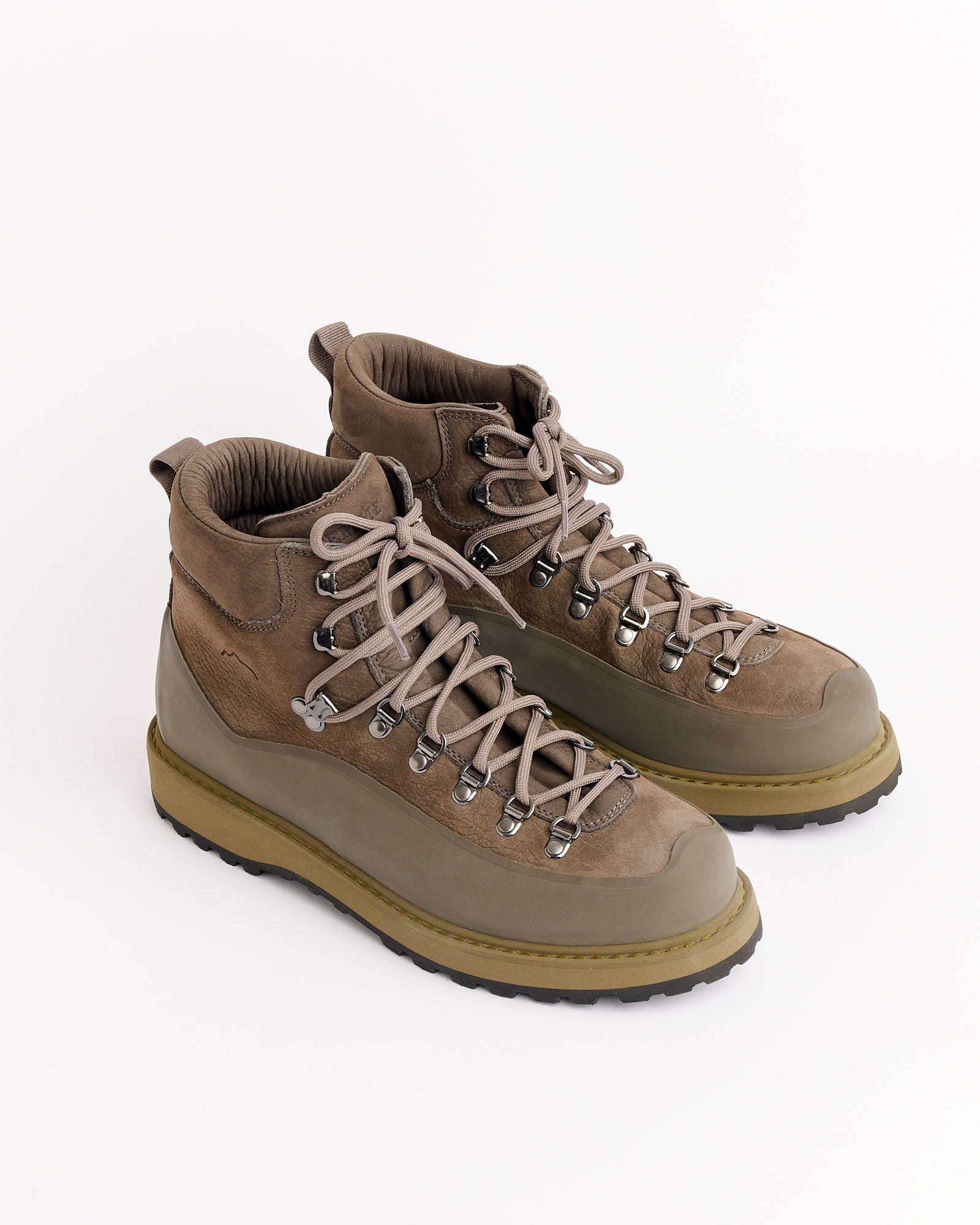 The Diemme Roccia Vet Gomma Boot in Smog features thick, textured soles and sturdy laces in brown and olive-green tones, displayed on a white background. For sizing help, contact our online chat team.