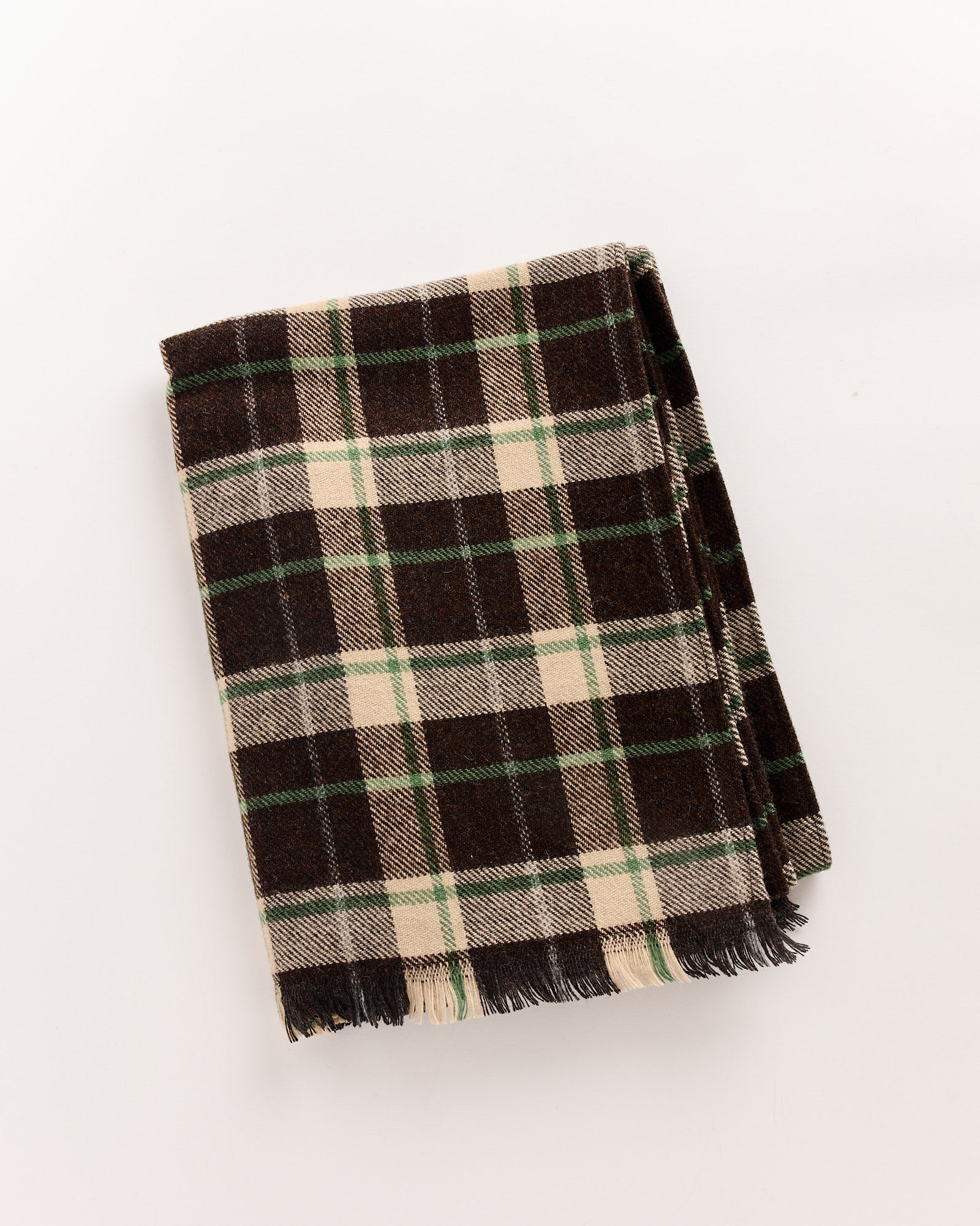 The Bode Woodcrest Scarf in Brown/Green by Bode, featuring fringed edges and a wool plaid pattern in brown, cream, and green tones, is shown folded on a plain white background.