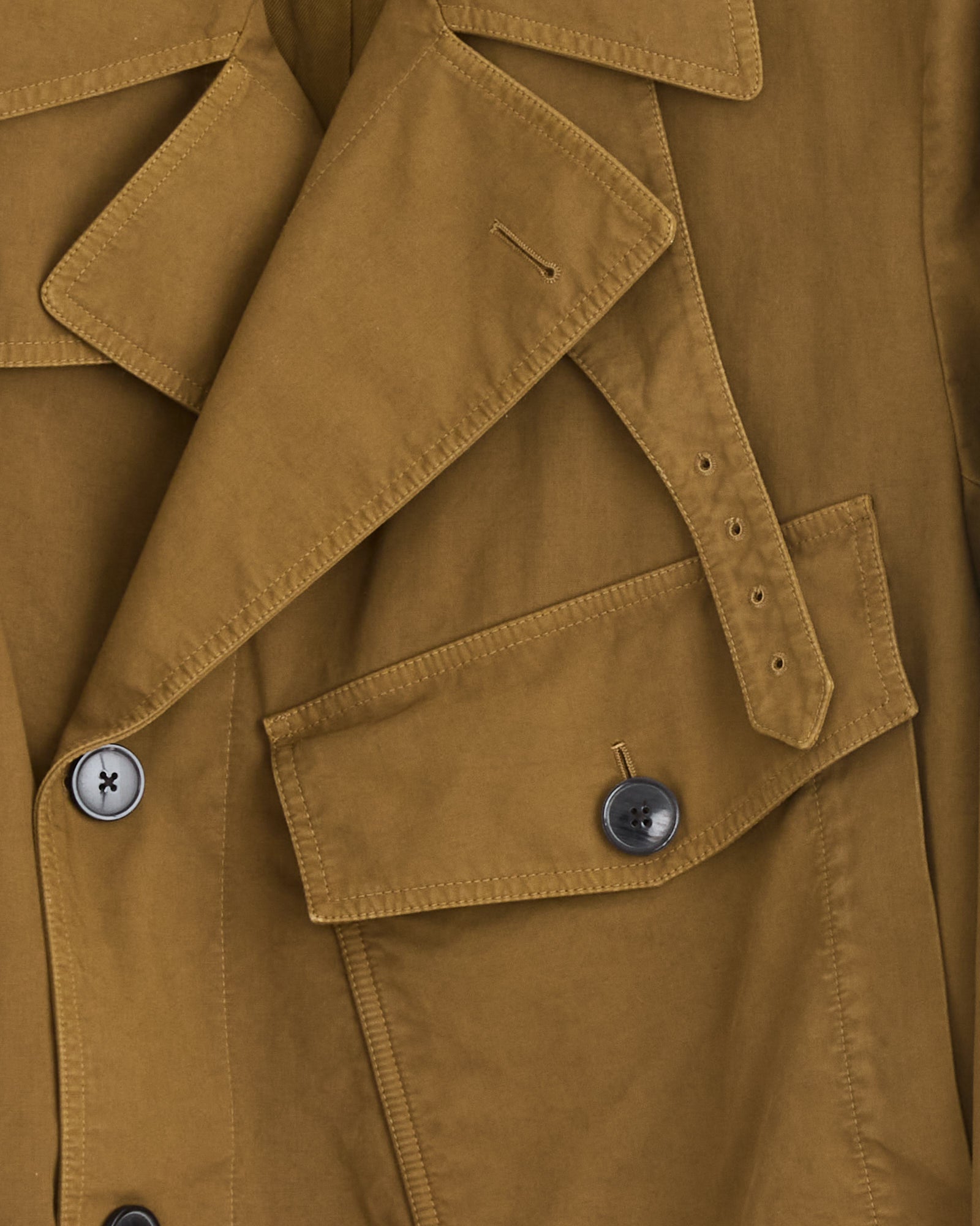 Close-up of the Dries Van Noten Belted Biker Jacket in Olive, highlighting its lapel, double-breasted buttons, belted shoulder strap with buttonholes, and flap pocket. The smooth fabric is neatly stitched and expertly crafted in Italy.