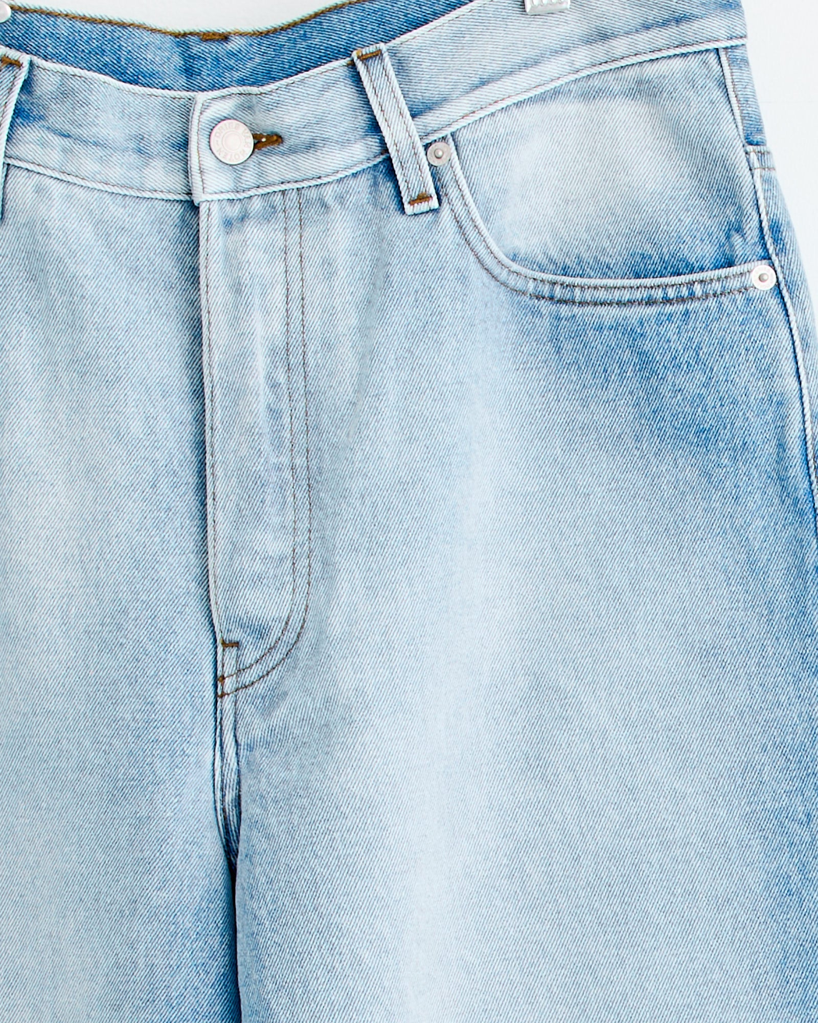 Close-up of Dries Van Noten Pine Den 2390 Pant in Light Blue, highlighting waistband, button, front pockets, belt loops, and stitching—ideal for evaluating fit and sizing before purchase.