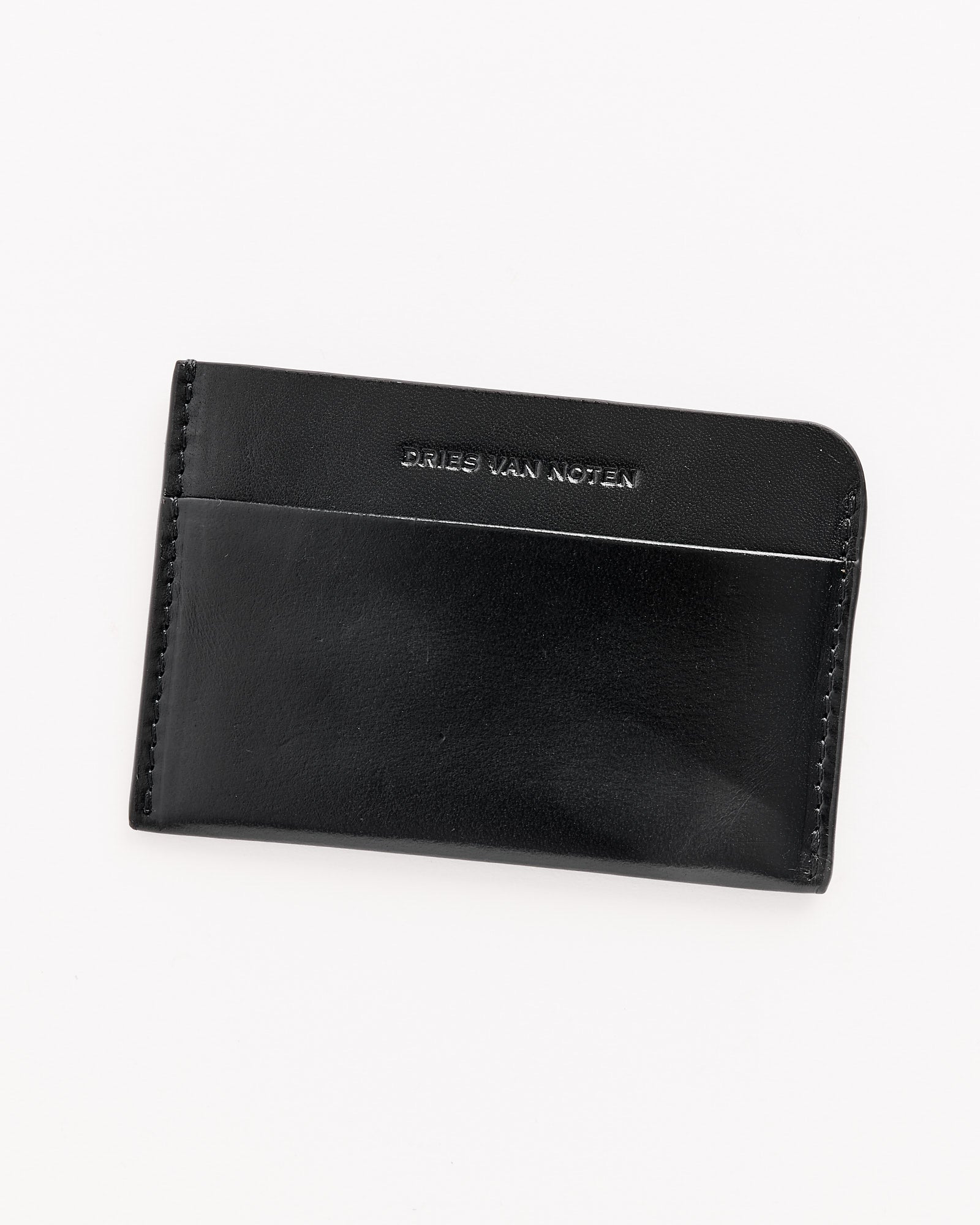 The Dries Van Noten 241-151 Leather Card Case in Black features visible stitching and embossed branding on the front, showcased against a plain white background.