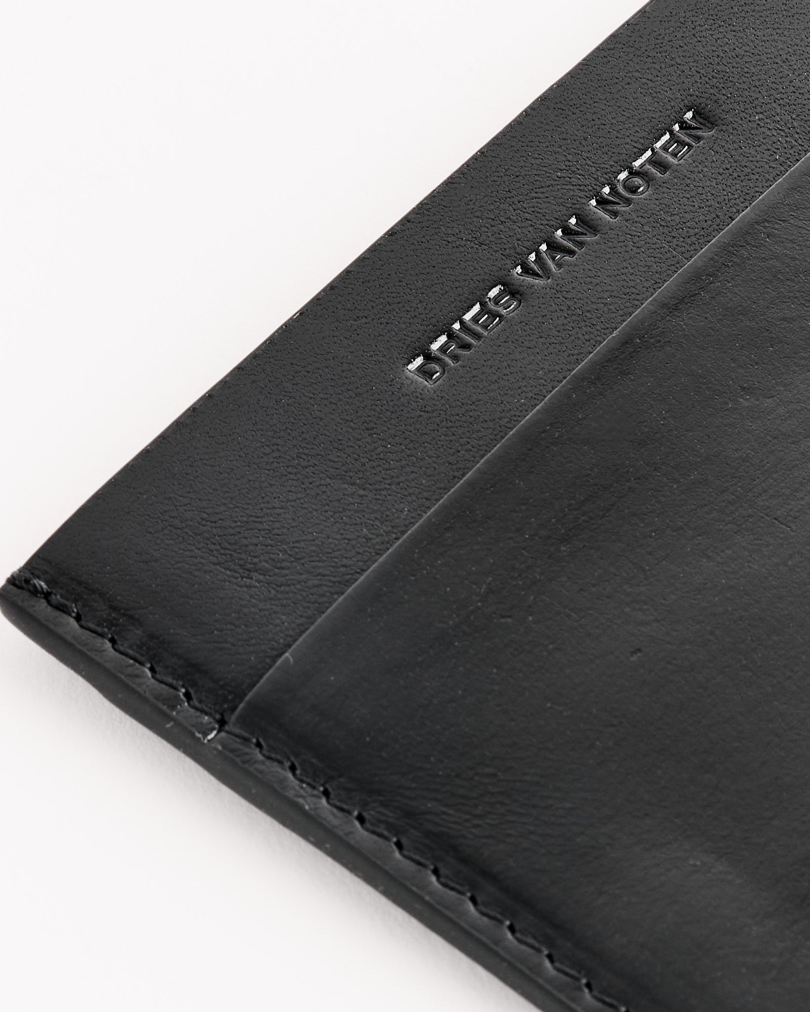 Close-up of the Dries Van Noten 241-151 Leather Card Case in Black, featuring visible stitching and embossed branding, highlighting its refined Italian craftsmanship.