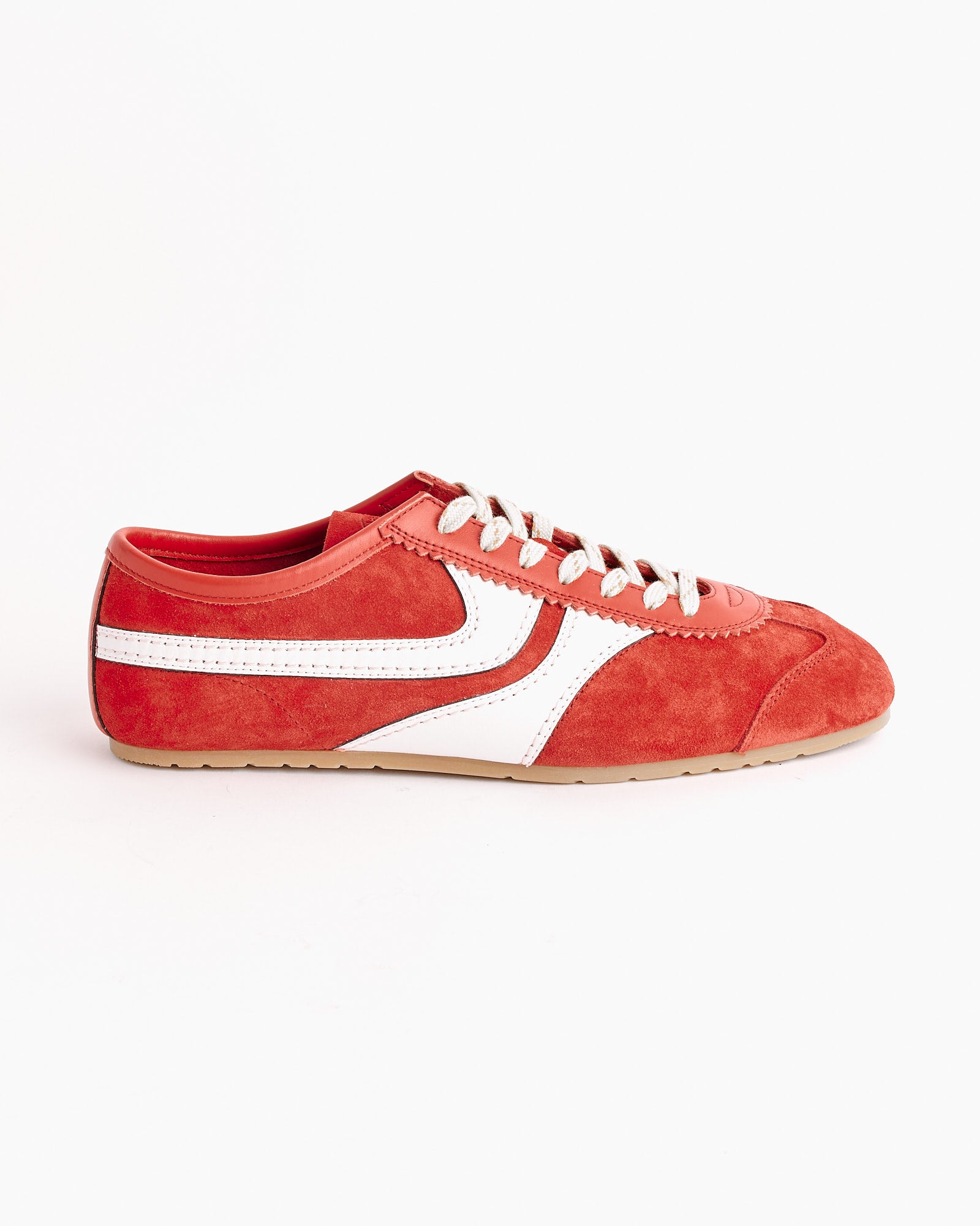 The Dries Van Noten Suede Shoes in Red feature white laces, a white side stripe, and a light brown rubber sole, shown against a plain white background.
