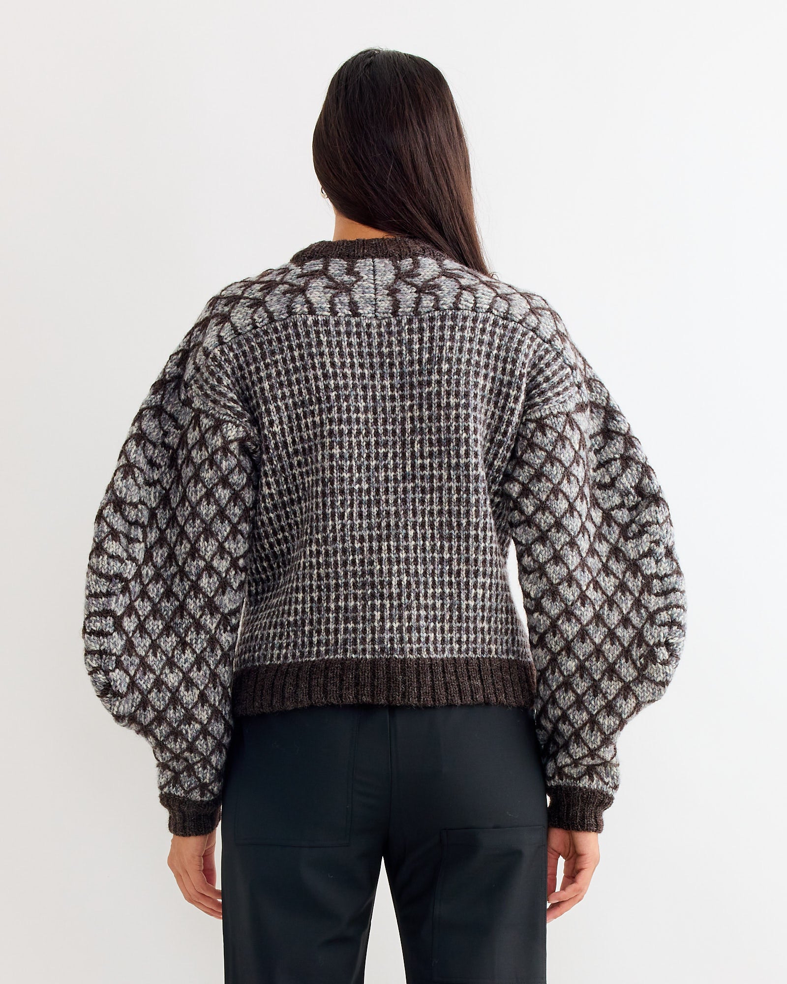 A woman wearing the Henrik Vibskov Kimchi Sweater in Brown Party.