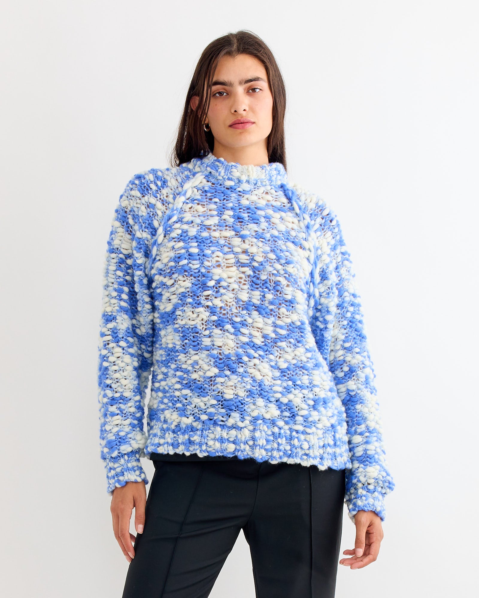 A woman wearing the Henrik Vibskov Bongo Sweater in blue.