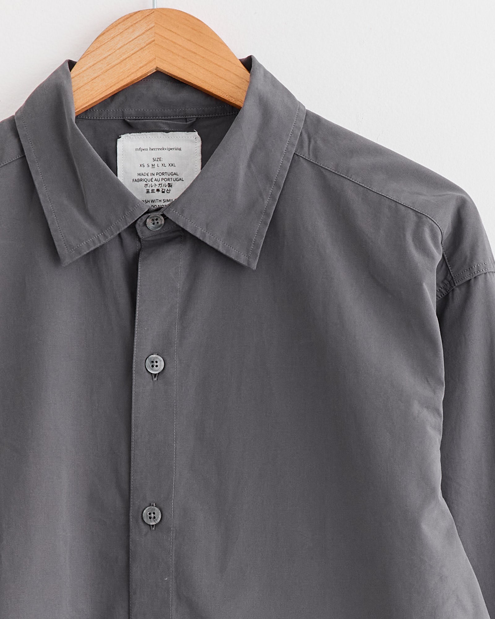 A relaxed-fit mfpen Generous Shirt in Mushroom, styled effortlessly on a swinger.