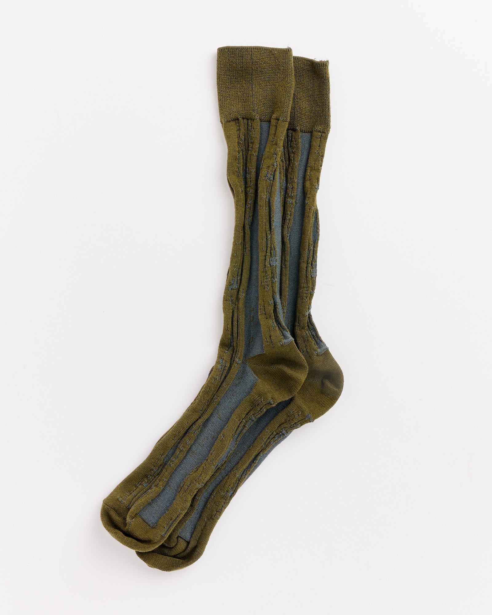 A pair of IM MEN Cotton Jacquard Socks in Green with vertical dark gray stripes is laid flat on a white background, one sock slightly overlapping the other. Inspired by Issey Miyake and expertly made in Japan.