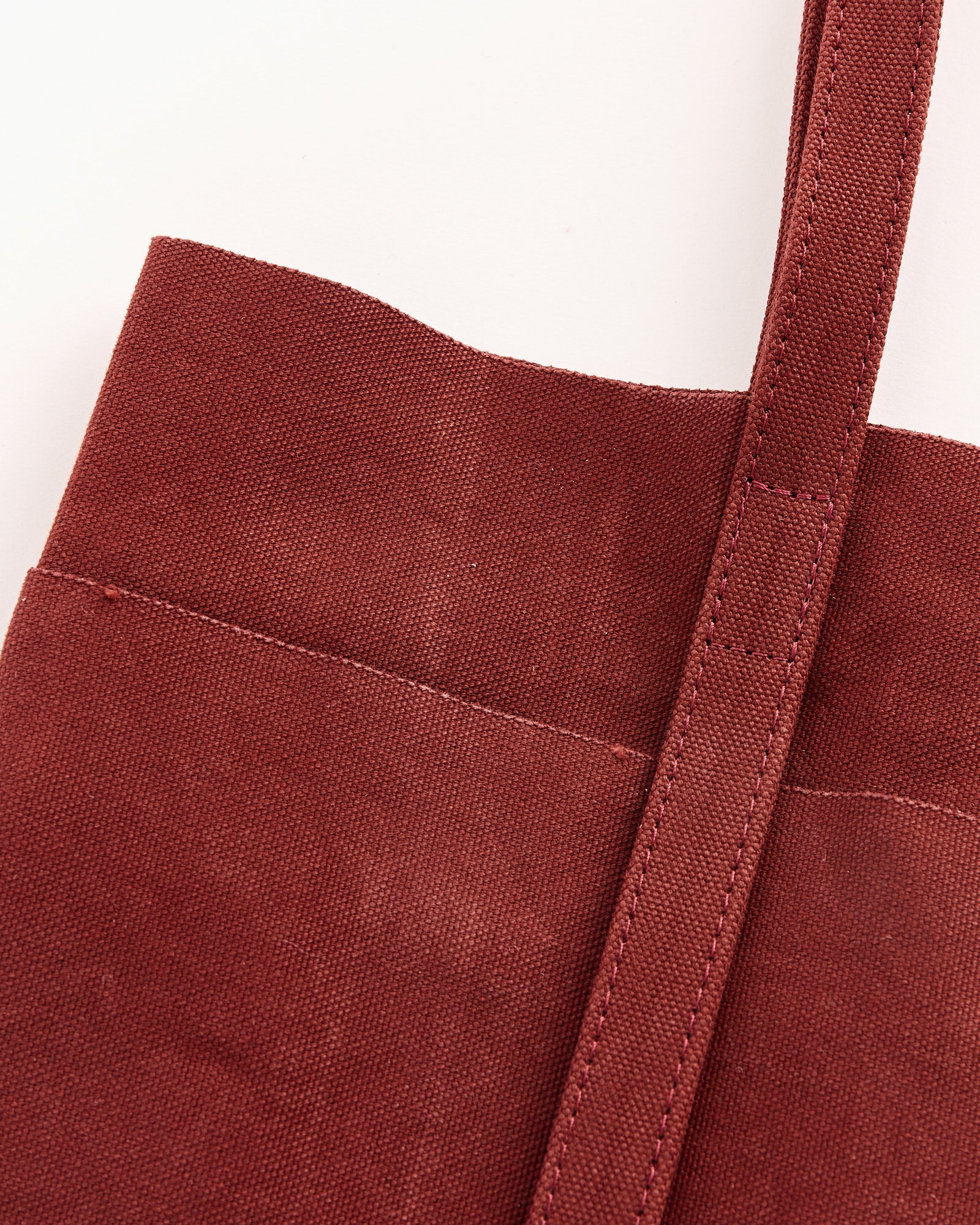 Close-up of the Amiacalva Washed Canvas 6 Pockets Small Tote in Burgundy, featuring a wide shoulder strap and visible stitching, shown against a plain white background.