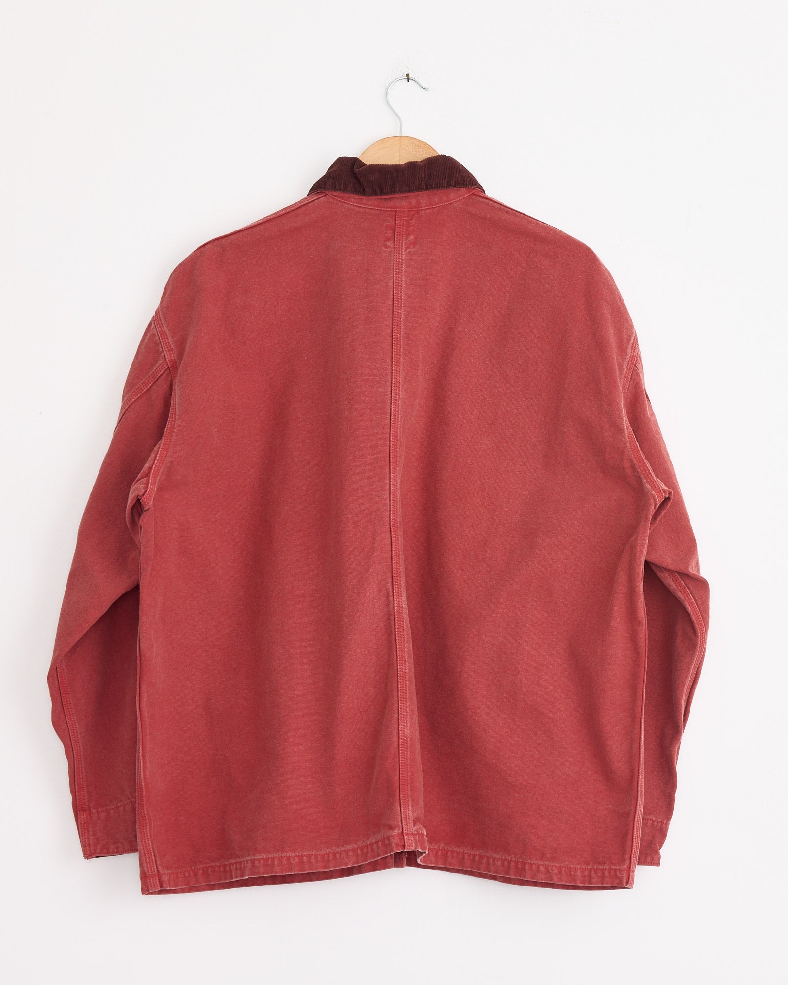 The orSlow Relax Fit Oxford Coverall in Red, with a brown corduroy collar, is shown hanging and photographed from the back against a plain white wall.