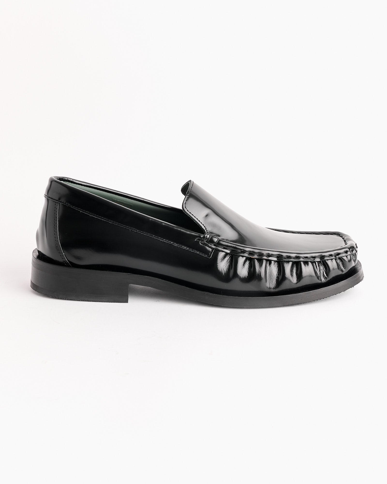 The Michel Loafer in Black by Vinny's is a shiny Polido leather loafer with a square toe, low heel, and moccasin stitching, displayed in a side profile on a plain white background.