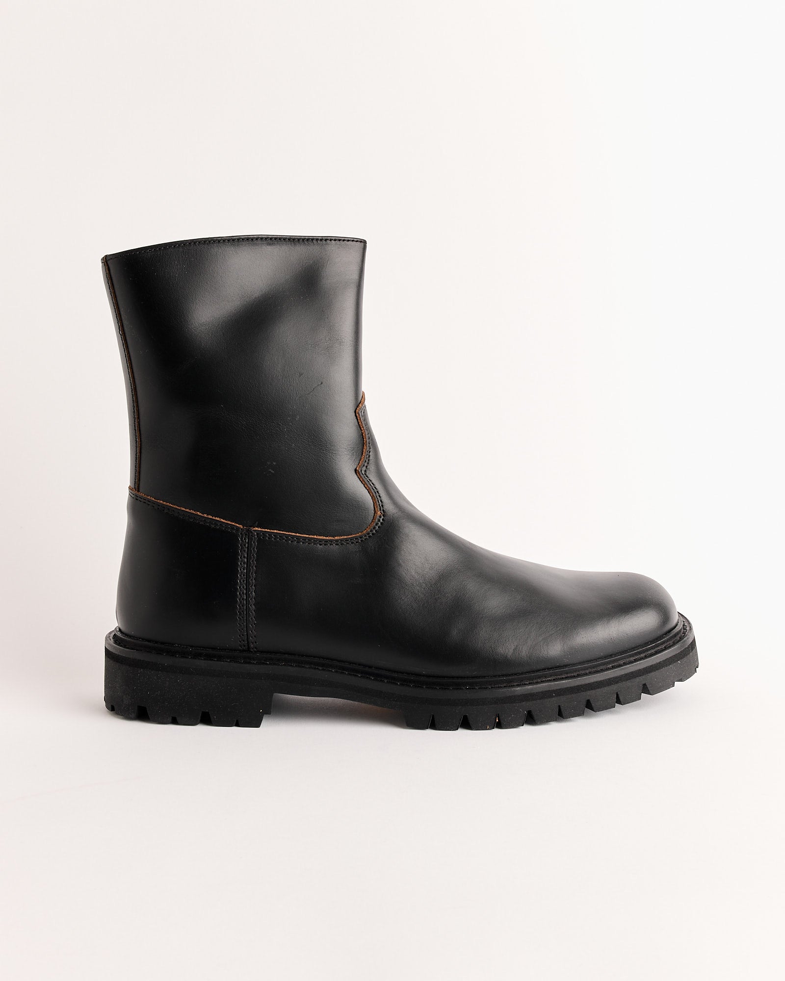 Vinny's Moto Boot in Black features nappa leather, a chunky Vibram sole, and visible stitching, shown in a single shoe against a plain white background.