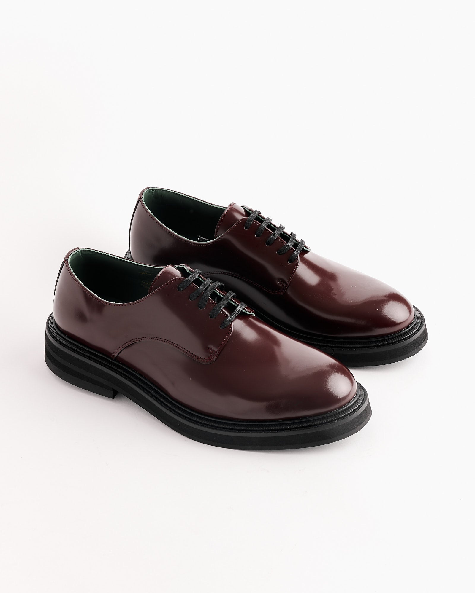 Vinny’s Officer Derby in Burgundy features shiny Burgandy Polido leather, black laces, and thick black soles, shown against a white background.