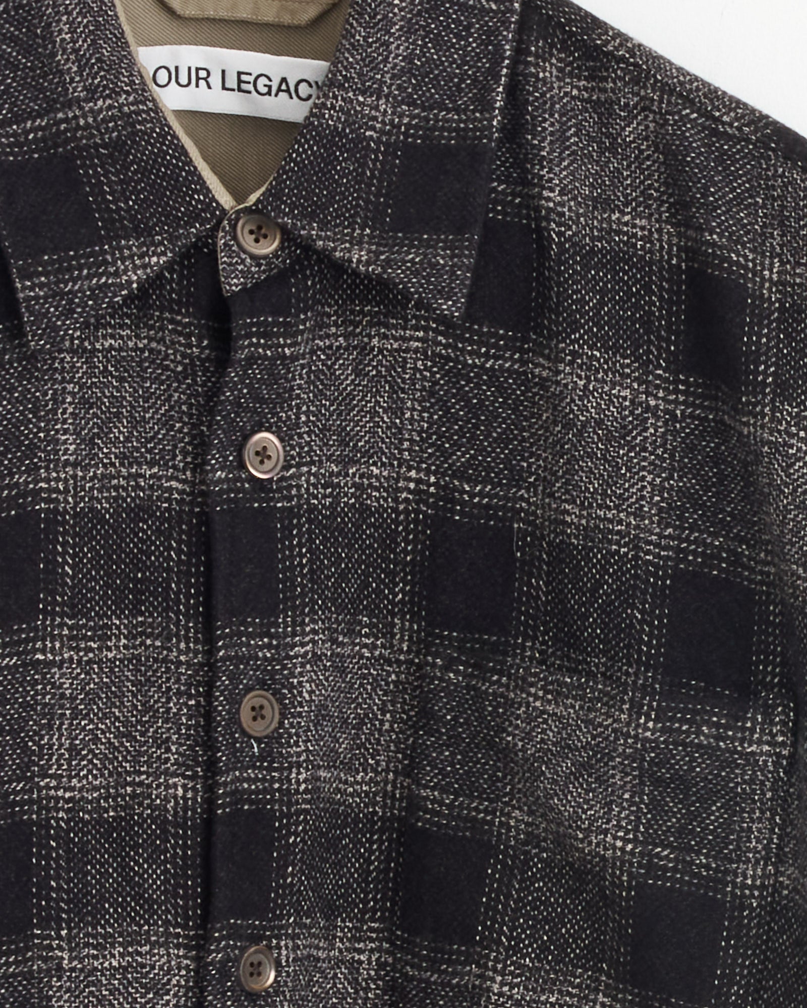 A close-up of the Our Legacy Above Shirt in Oakland Low Twist Check, crafted from premium Japanese cotton and showcasing its soft texture with a subtle check pattern.