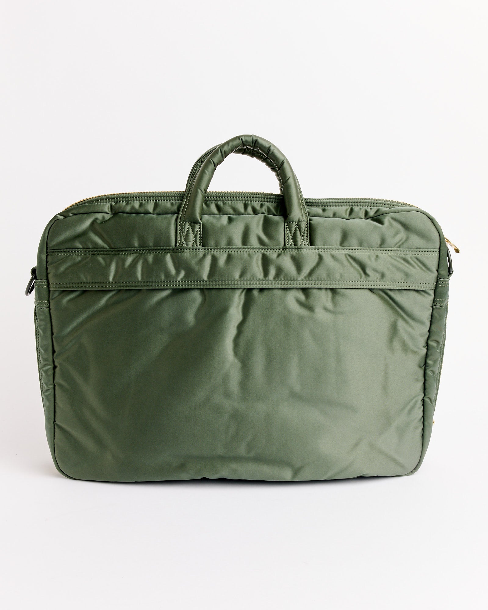 The Porter Tanker 2Way Document Zip Bag in Sage Green features two short top handles, a zipper closure, and a front pocket, shown against a plain white background.