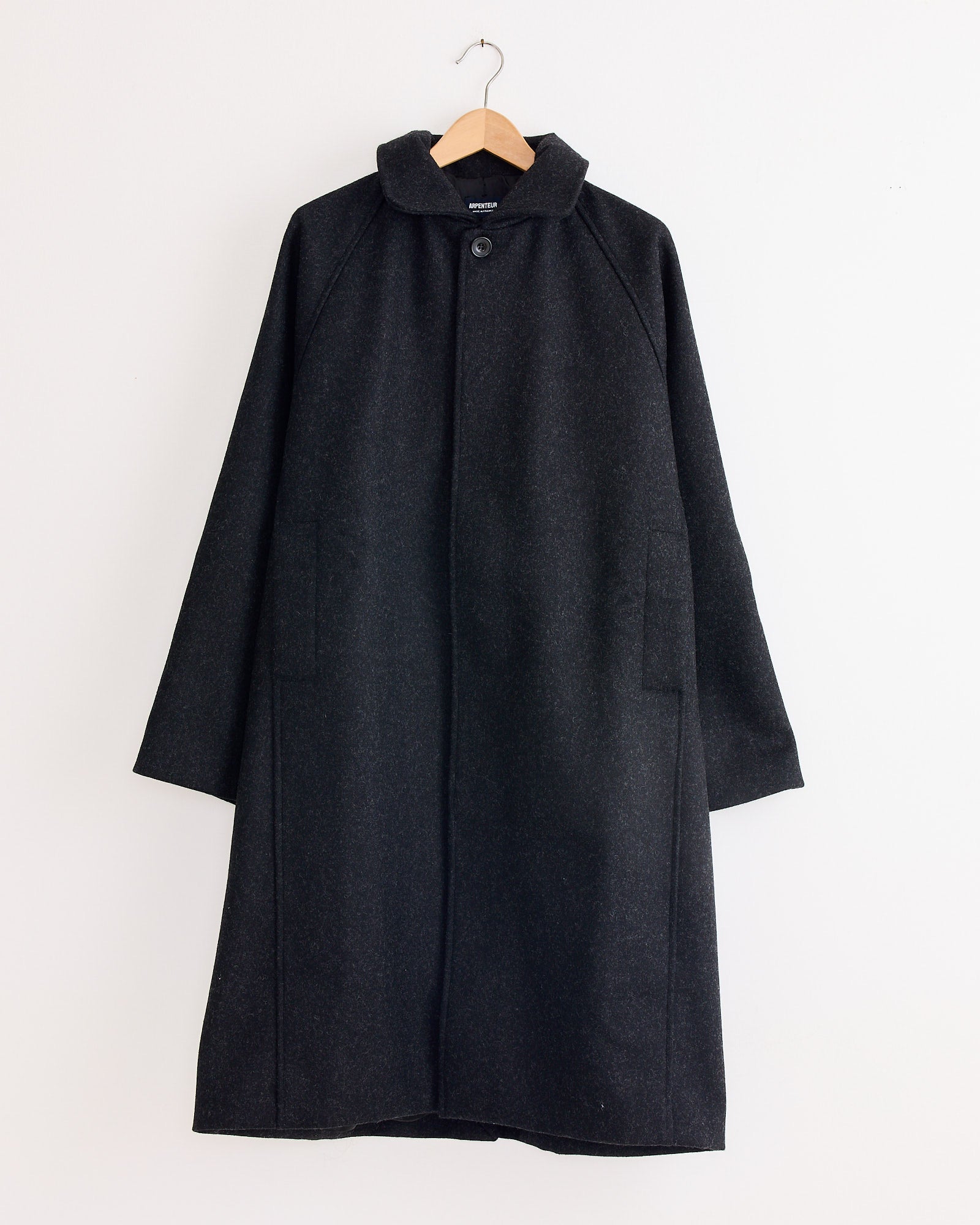 An Arpenteur Utile Lined Wool Coat in charcoal, expertly tailored and made in France.