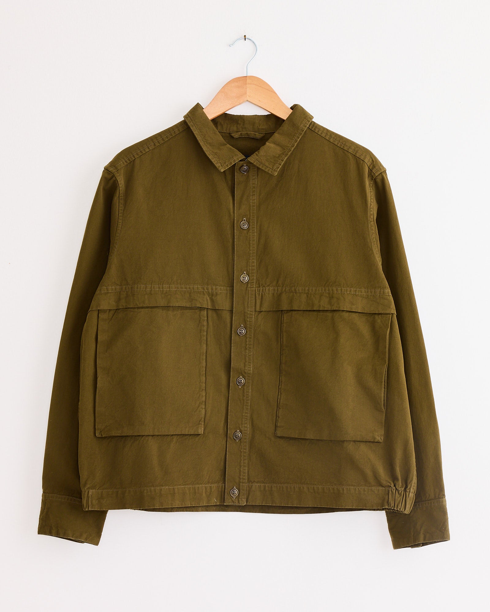 A Casey Casey Fabu Shirt in Green Lake, made from 100% cotton, layered casually on a swinger.