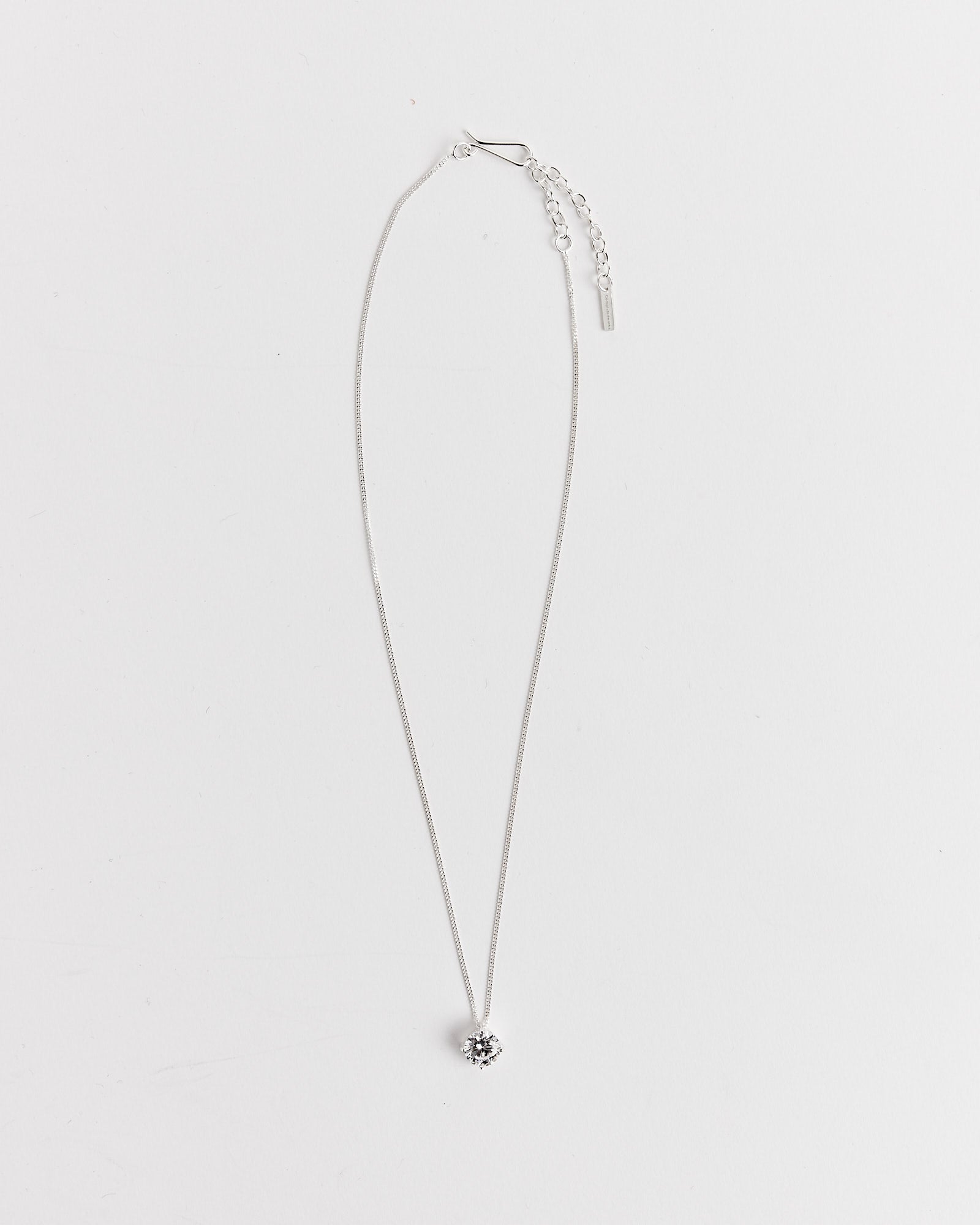 The Completedworks Recycled Silver CZ Necklace features a delicate 17.5" silver-plated chain with a single round clear gemstone pendant, shown against a plain white background.