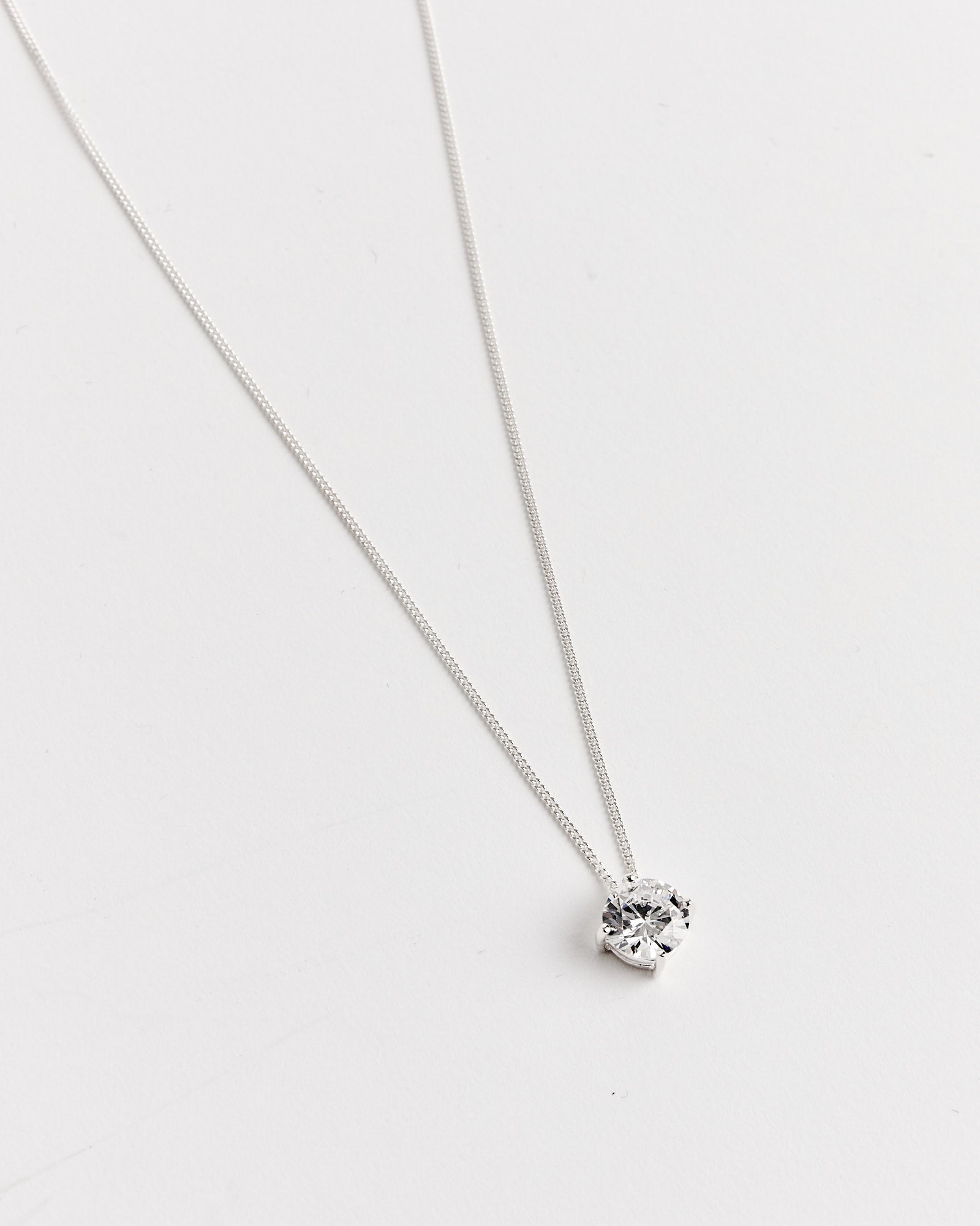 The Completedworks Recycled Silver CZ Necklace is a simple 17.5" piece featuring a single round pendant, shown on a white background.