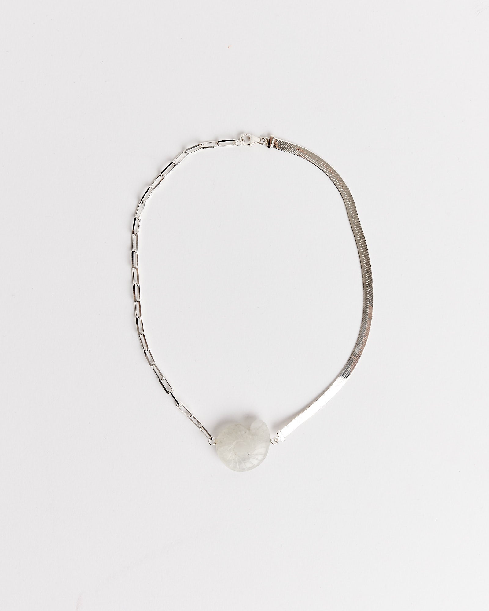The NOMIA Crystal Shell Choker in Silver/Rainbow Moonstone features two unique chain styles and a single round, marble-like rainbow moonstone charm. Displayed on a white background. Chat with us online for sizing advice and the perfect fit.
