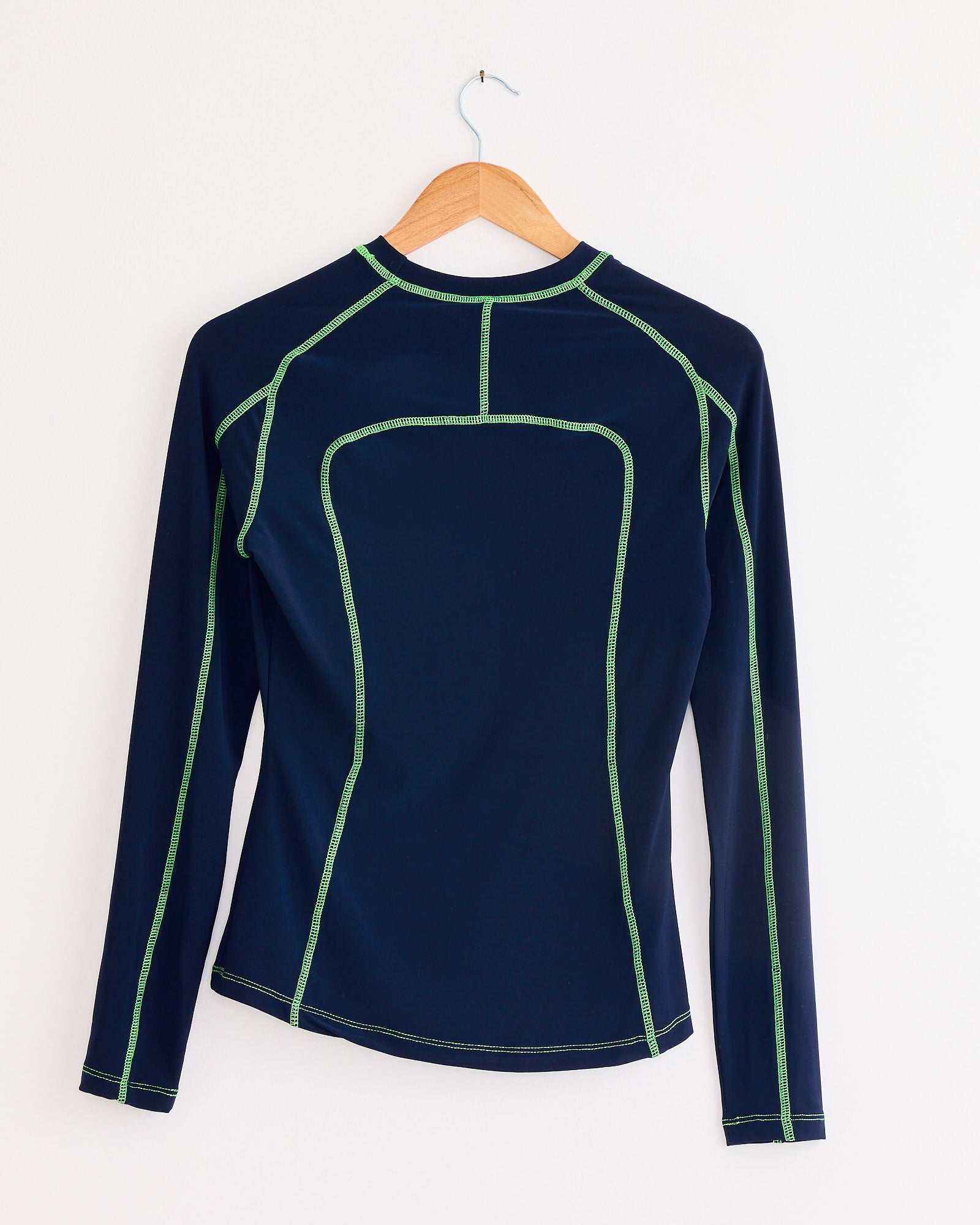 The NOMIA Paneled Scuba Top in Ink / Grass features vibrant blue and green hues—this stylish long-sleeve top is perfect for any occasion.