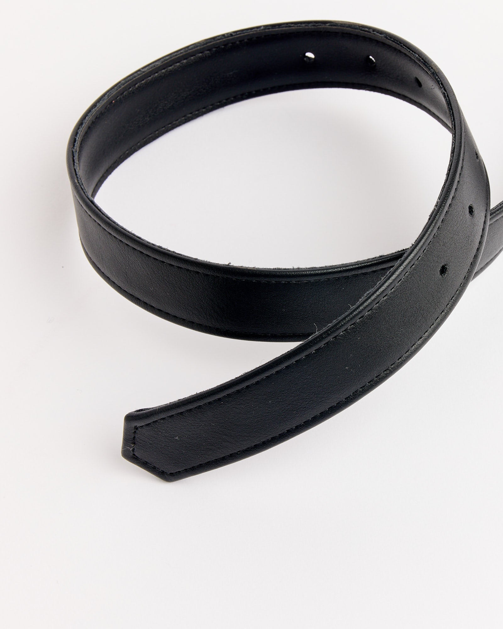 The NOMIA Faux Leather Spiral Buckle Belt in Silver features a black coiled design with visible stitching and punched holes, shown on a plain white background. Chat online for sizing or fit questions to find your perfect accessory.