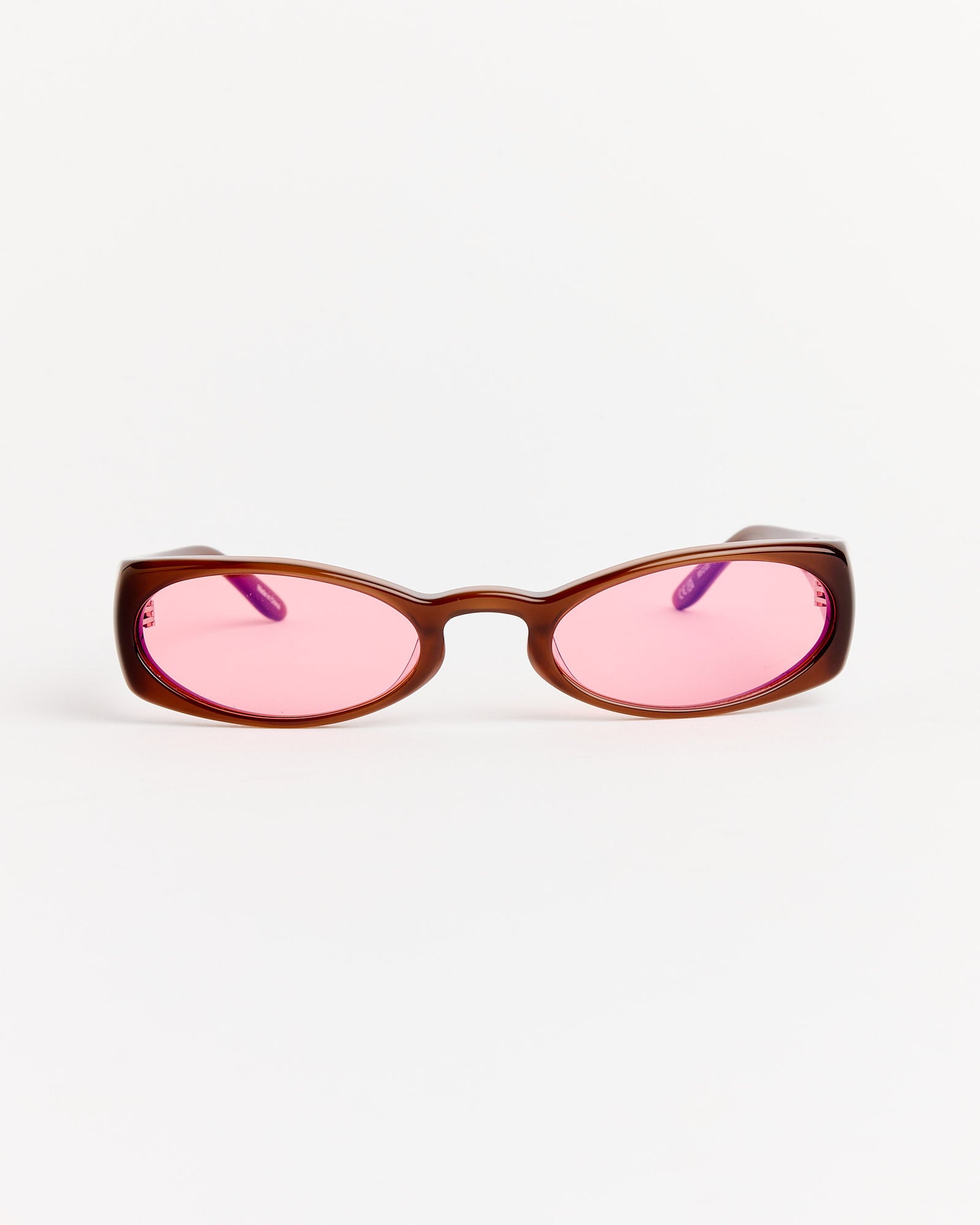 The Henrik Vibskov Megan Sunglasses in Brown/Red feature brown acetate oval frames and pink-tinted lenses, shown against a plain white background.