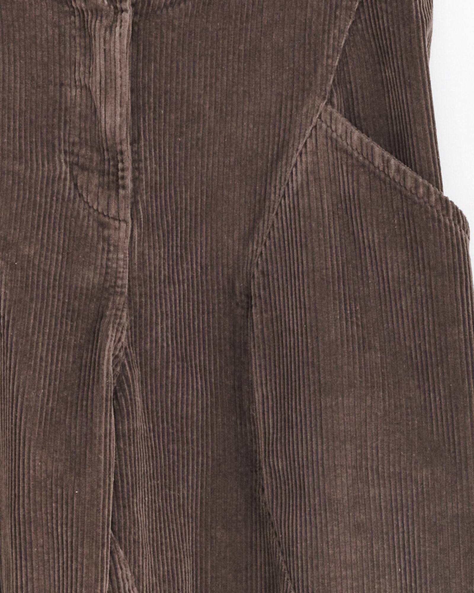Close-up of Henrik Vibskov Digi Corduroy Pant in Chocolate Brown, highlighting its vertical ribbed texture, visible front seam, pocket detail, stitching, and the rich, soft corduroy fabric.