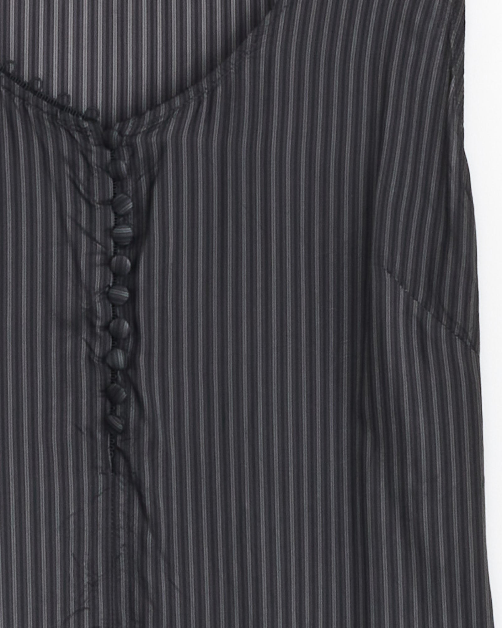 Close-up of the Dries Van Noten Dommy Stripe Crepe Midi Dress in Grey, featuring slim vertical stripes, a front row of black buttons, and asymmetric draping for a modern touch.