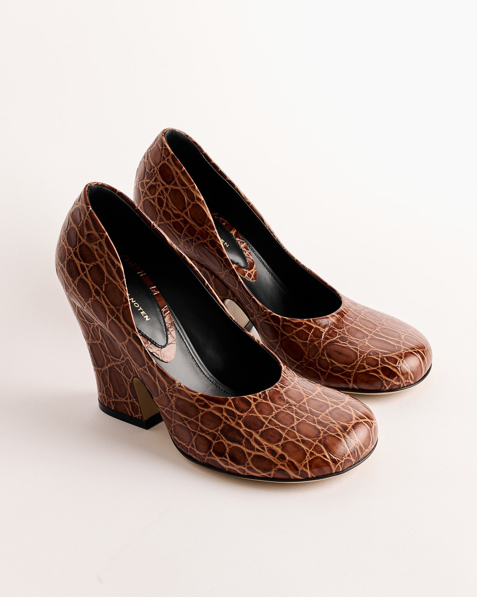 The Dries Van Noten Embossed Heel in Tan features closed toes, high heels, and a faux crocodile skin pattern, shown side by side on a light background.