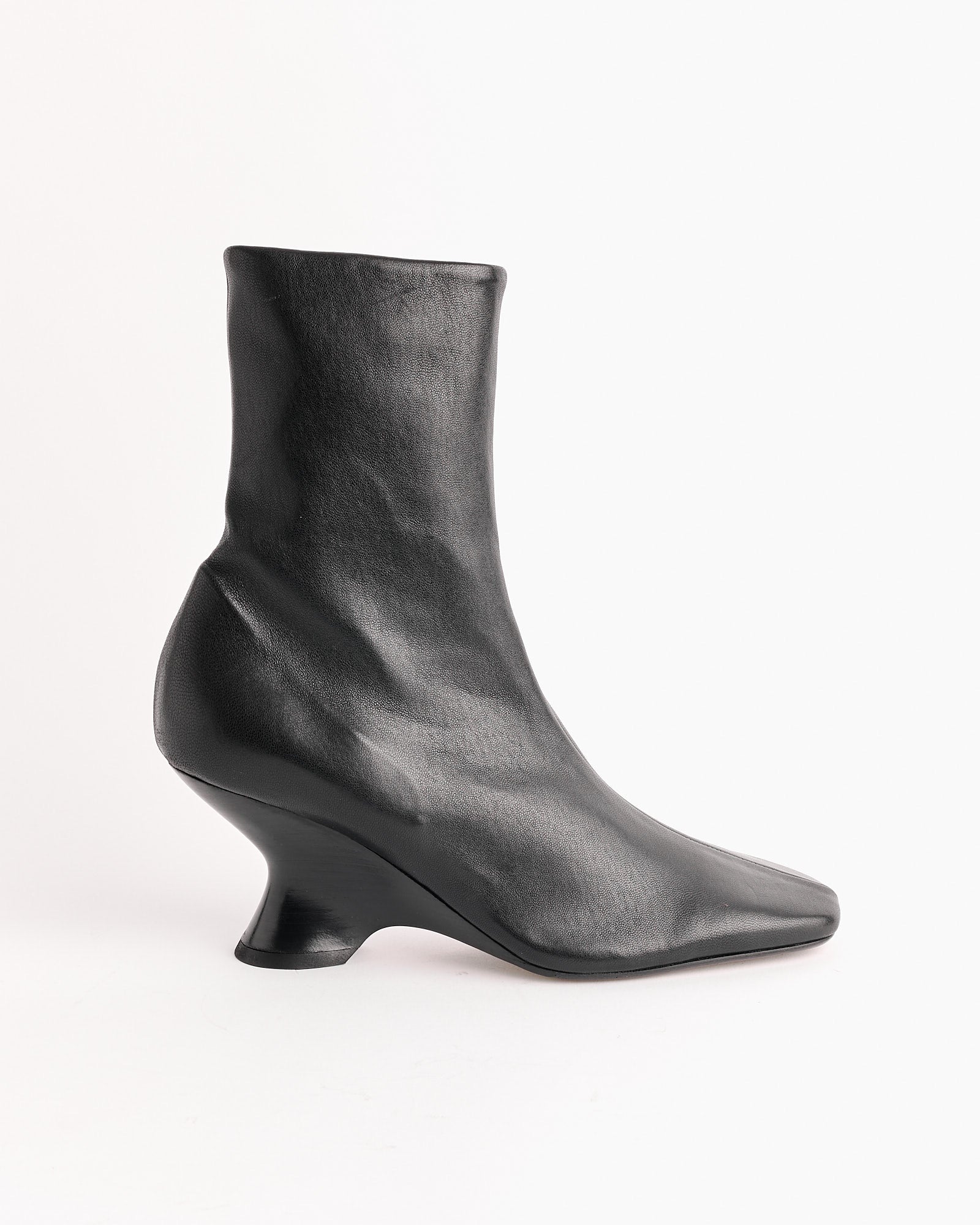 The Dries Van Noten Leather Wedge Boot in Black features a high heel and premium leather, offering a sleek, modern edge.