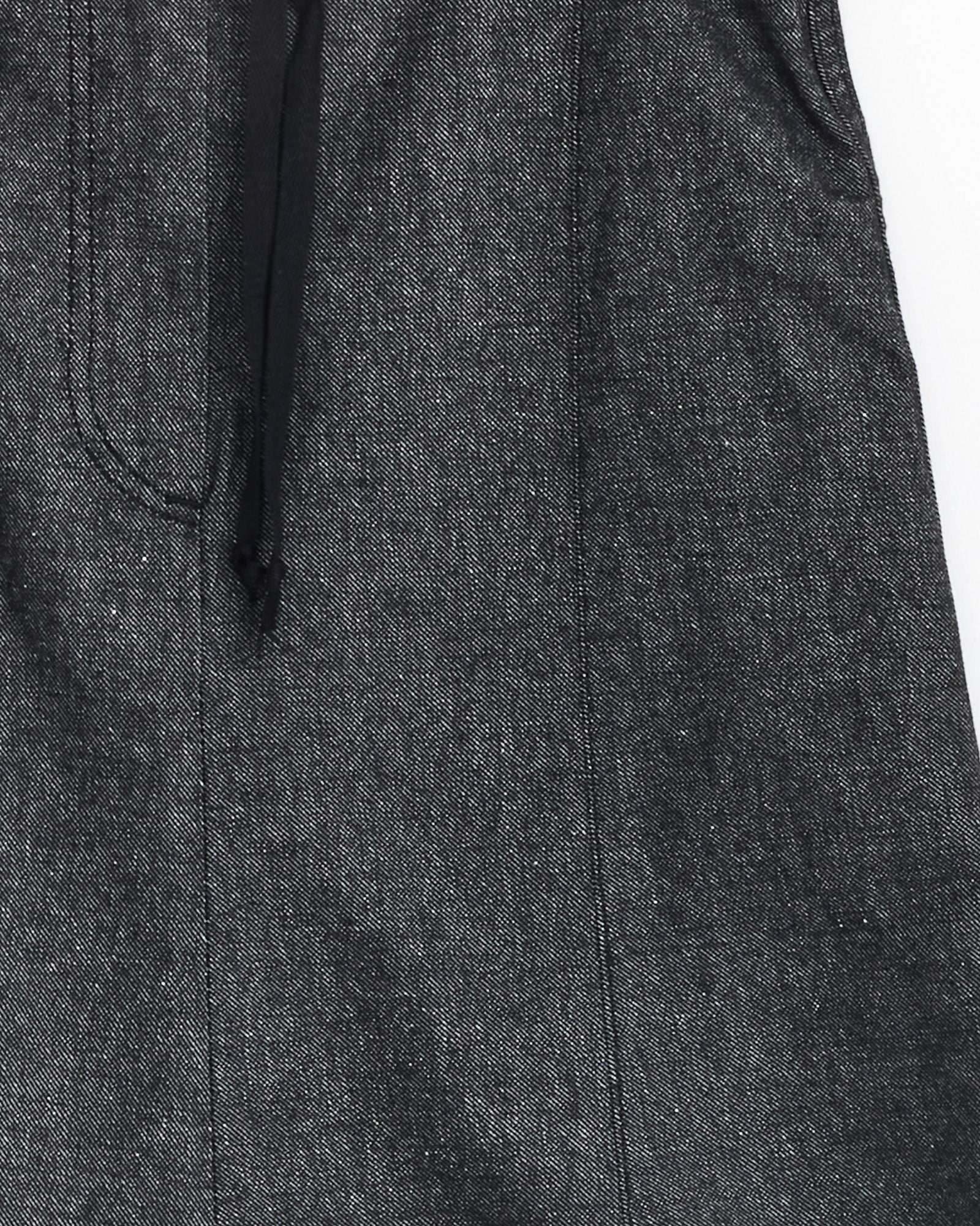 Close-up of the Arthur Skirt in Black by Baserange, showcasing dark grey denim fabric with visible stitching and a black drawstring waist.