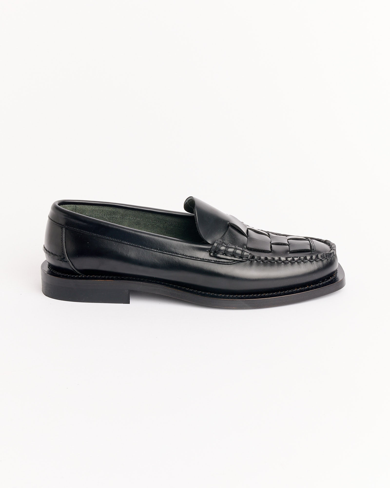 The Hereu Nombela Loafer in Black features a moccasin-style toe and low heel, shown in profile on a white background—ideal for those seeking the perfect fit and easy sizing when shopping online.