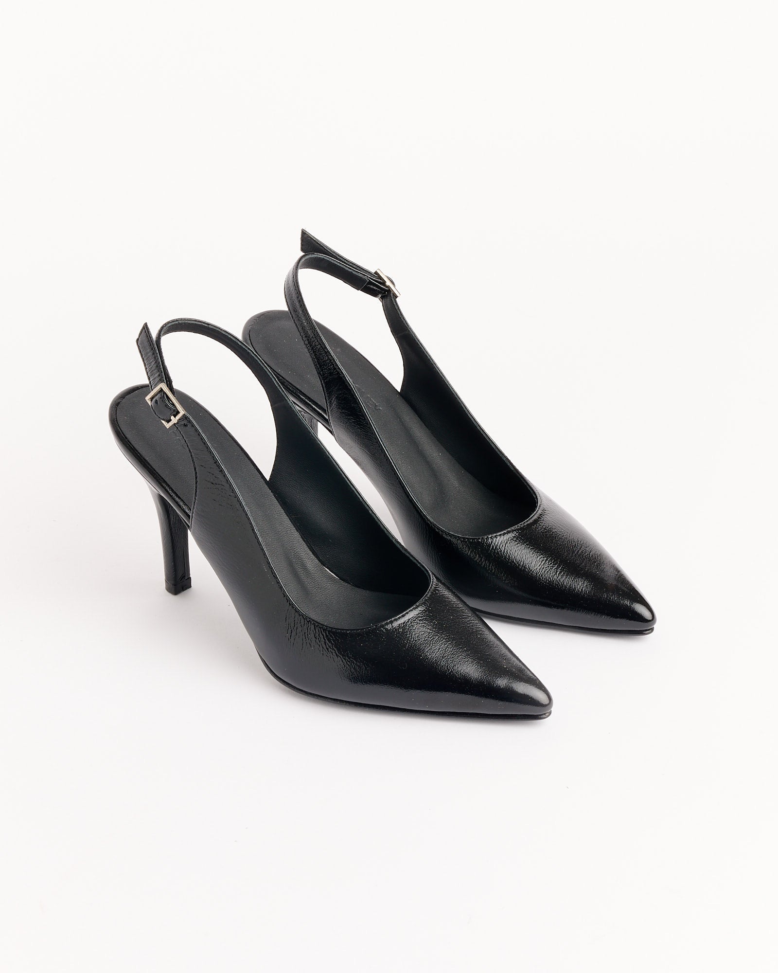 The Rachel Comey Cheke Sling Back Heel in Black features pointed toes and slim heels, shown on a white background.