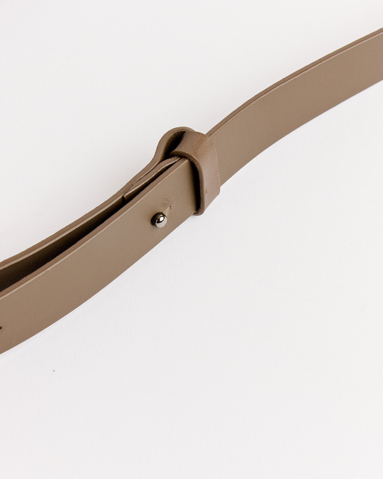 A close-up of the Amomento Small Padded Bag in brown with a simple design, displayed on a white background. The padded texture and compact shape highlight the brand's minimalist style.