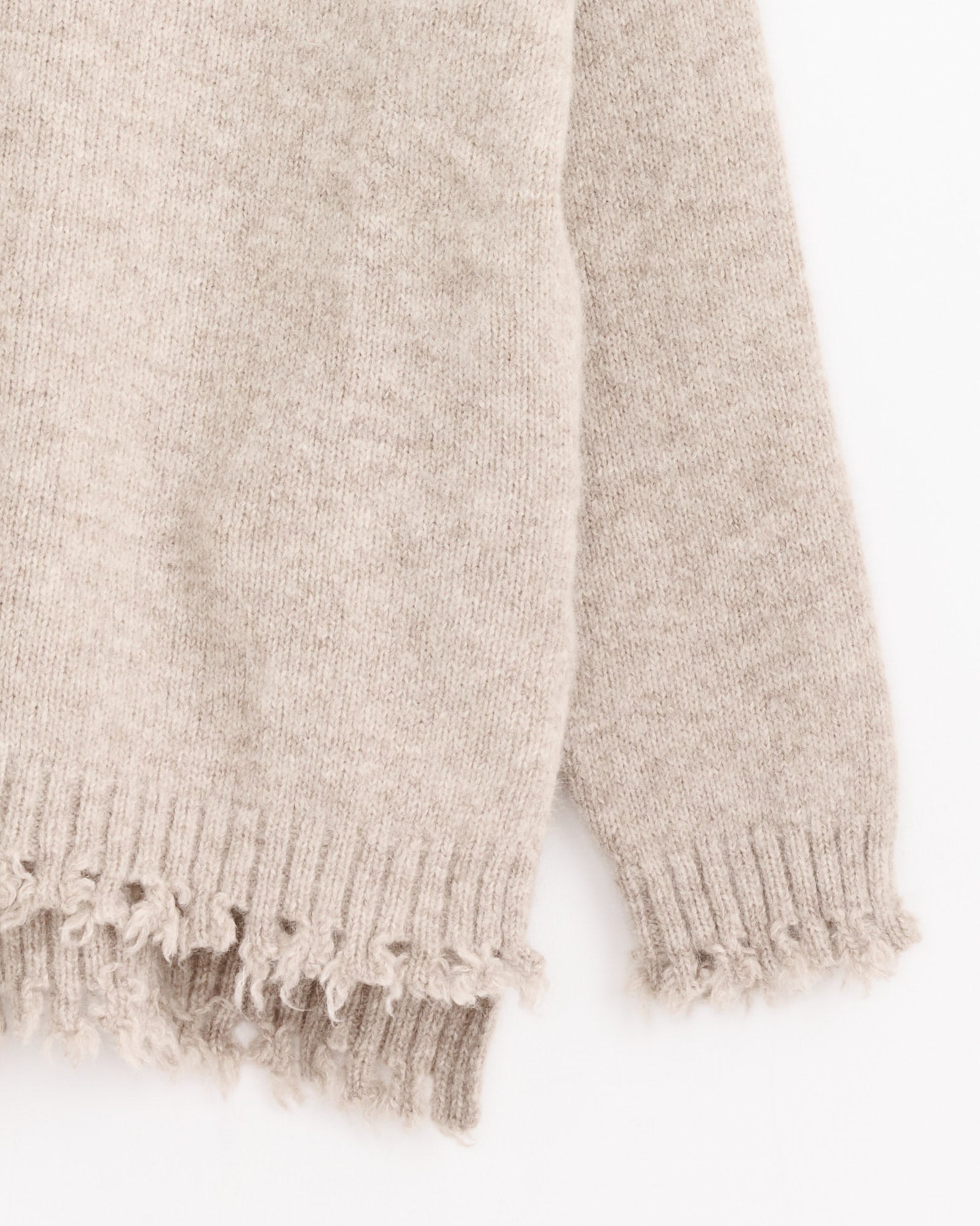 A close-up of Lauren Manoogian's Fray Crewneck in Aspen, featuring frayed edges at the hem and cuffs, set against a white background.