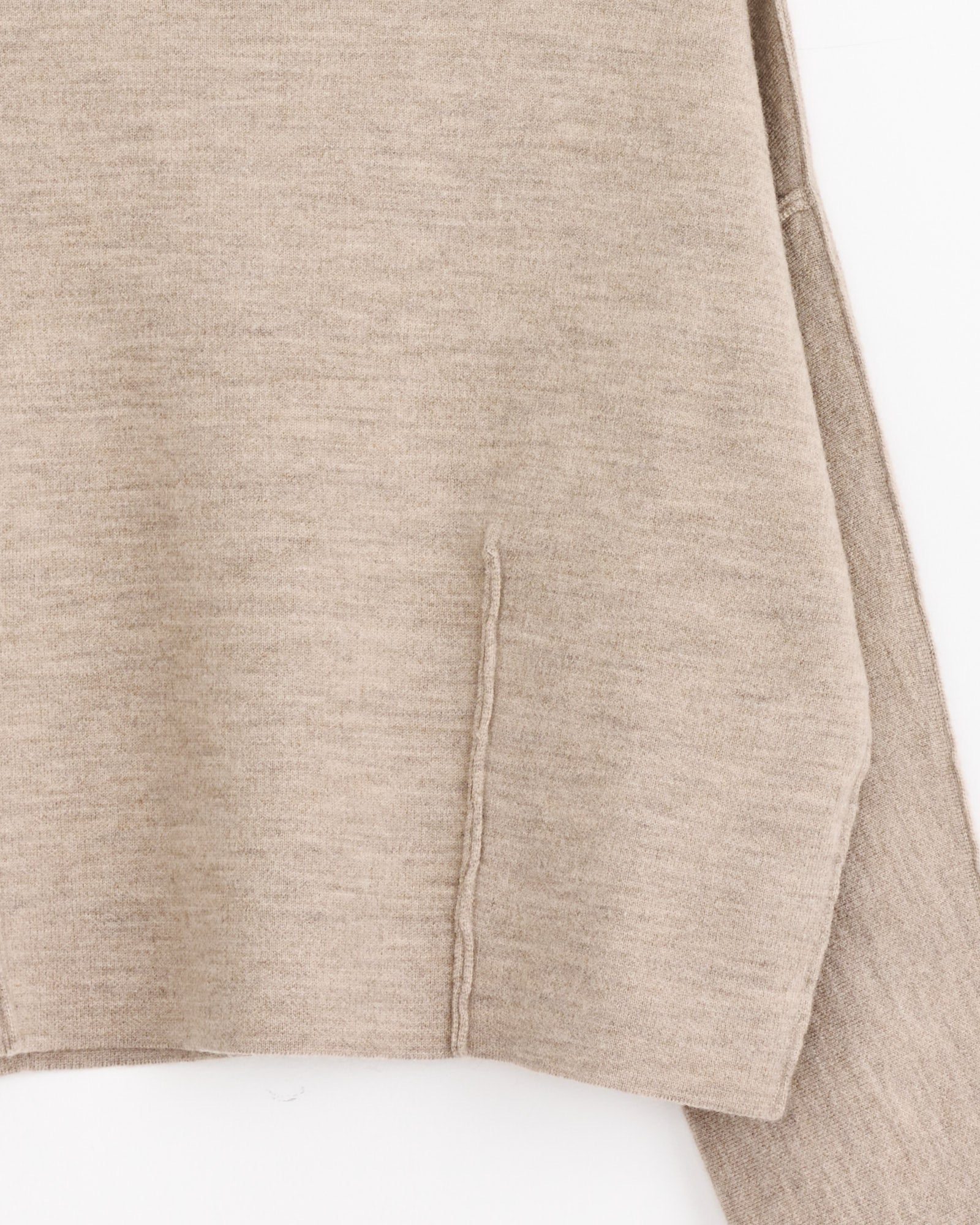 Close-up of the Double Knit Boatneck in Oak by Lauren Manoogian, highlighting sculptural knitwear details, a side pocket, and part of a sleeve against a white background.