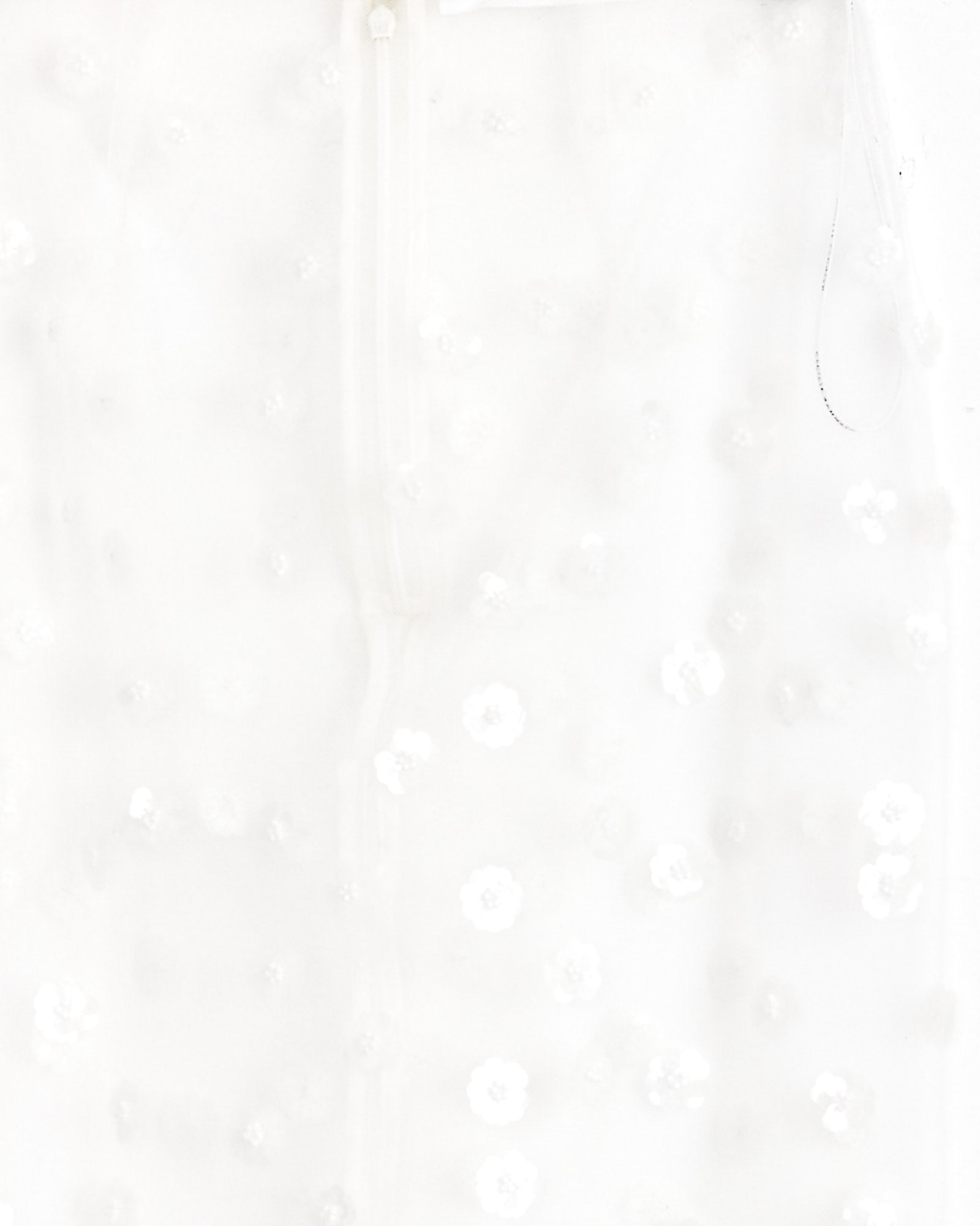 Close-up of the Gus Skirt in White Sequin by Cecilie Bahnsen, featuring sheer embroidered fabric adorned with small translucent floral sequins for a delicate, textured look.