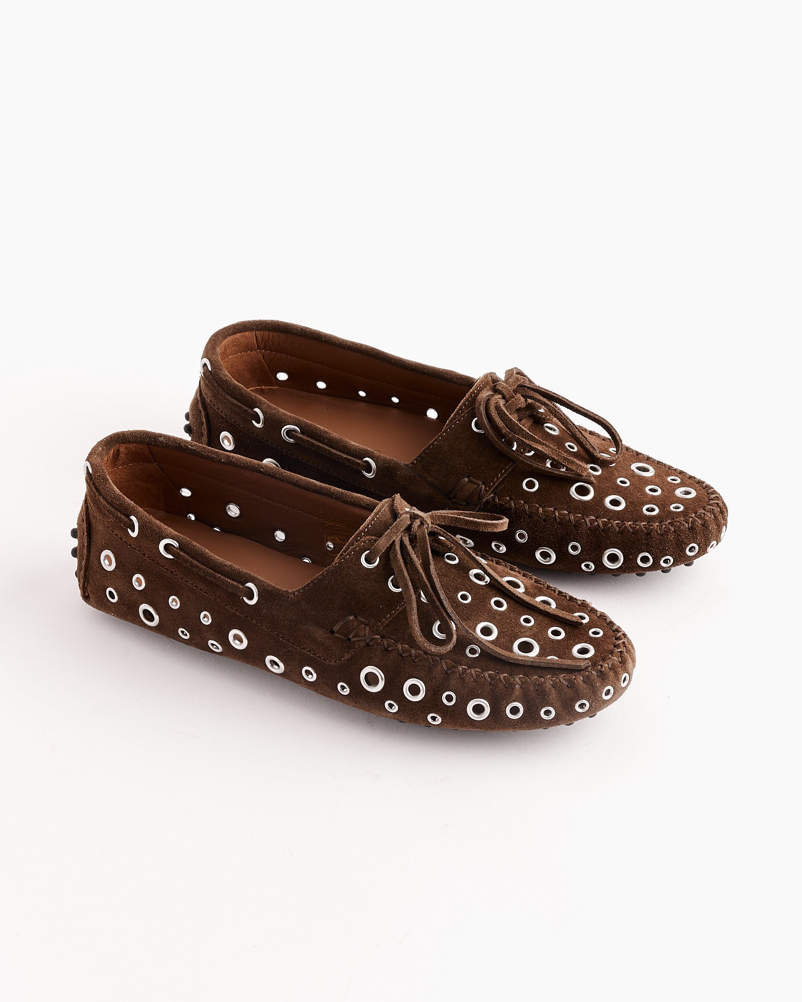 The Car Eyelets Shoes in Brown by Gimaguas are Italian-made loafers in brown suede, detailed with leather laces and multiple white eyelets across the surface.