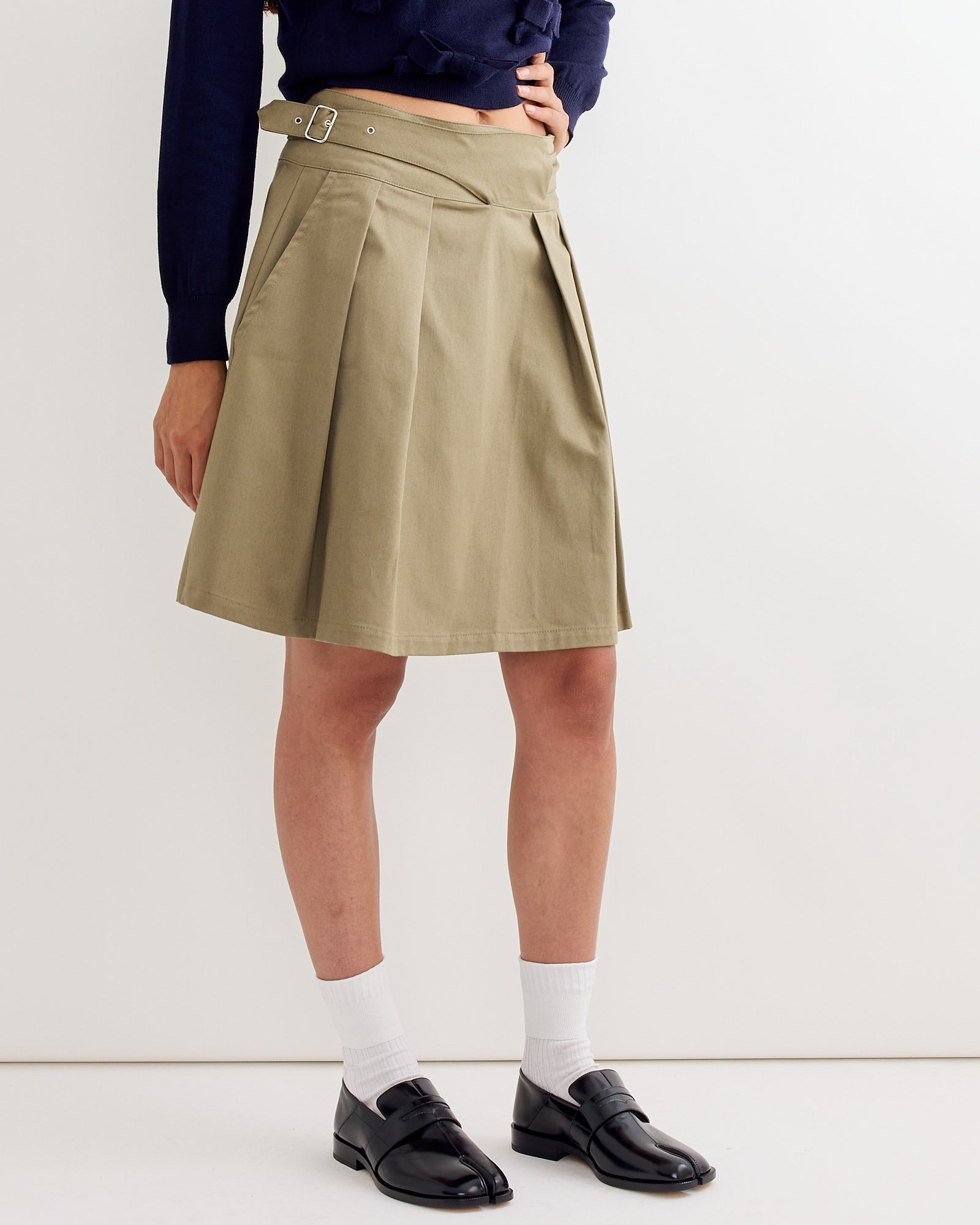 A person wearing the Martin Midi Skirt in Light Khaki by Gimaguas.