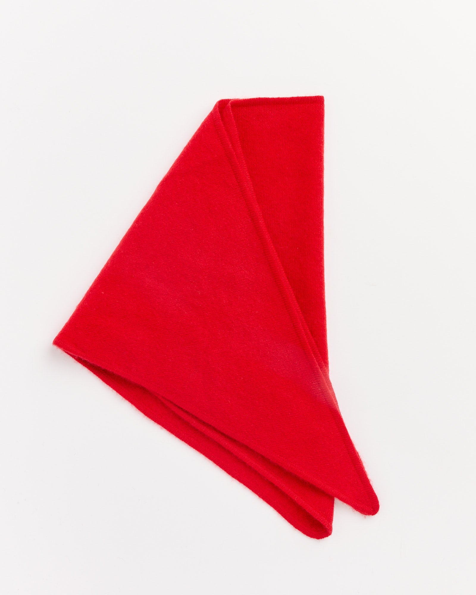 The Sophia Scarf in Red by Hai, a vibrant triangle scarf with pointed ends, is neatly folded and displayed on a plain white background.