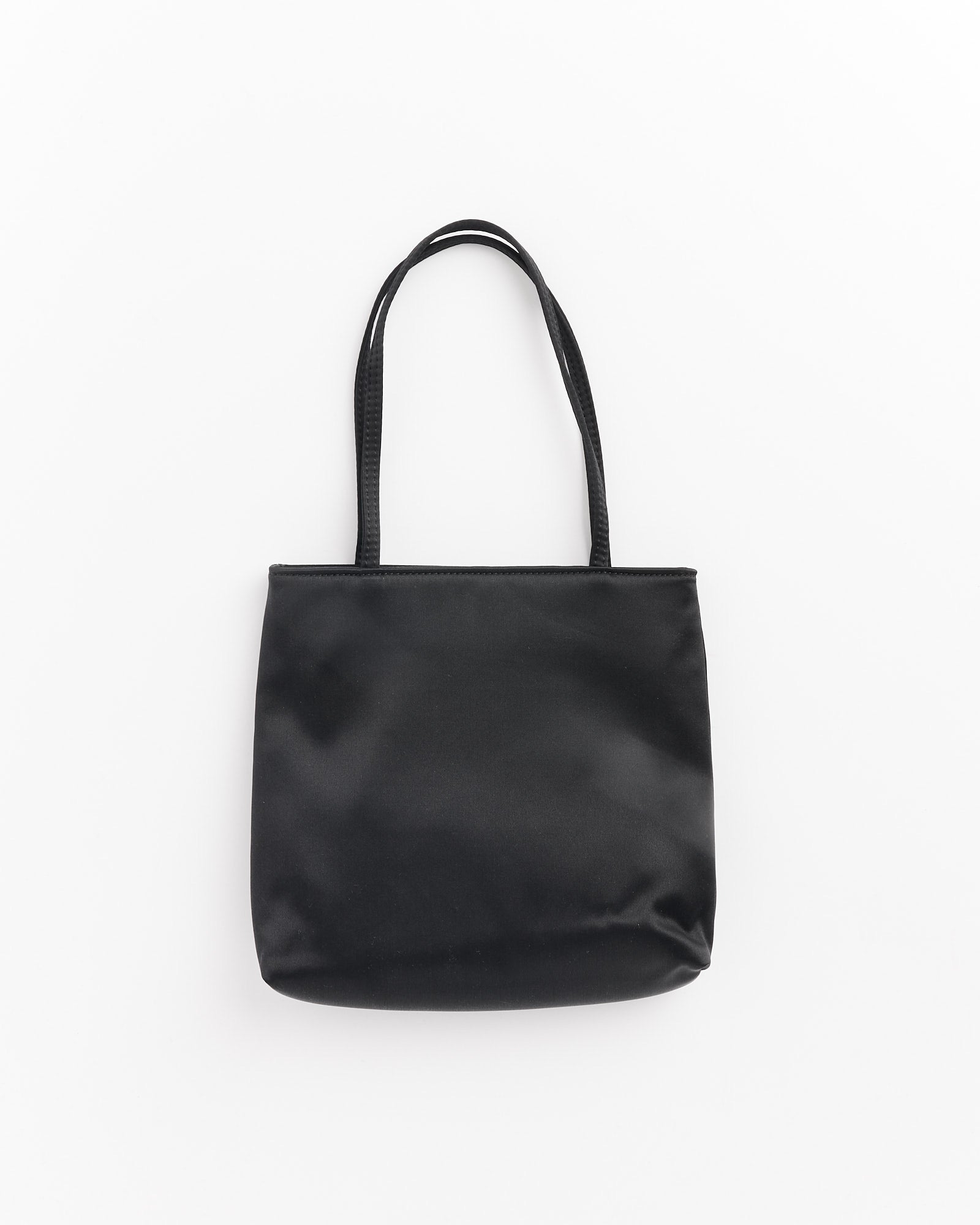 The Hai Bobbie Bag in Black, featuring two handles and crafted from smooth fabric inspired by mulberry silk, is shown against a white background.