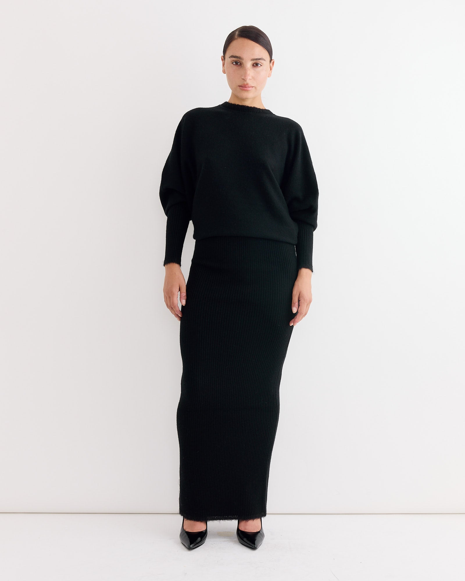 A woman in the Gislaine Dress in Black by By Malene Birger.