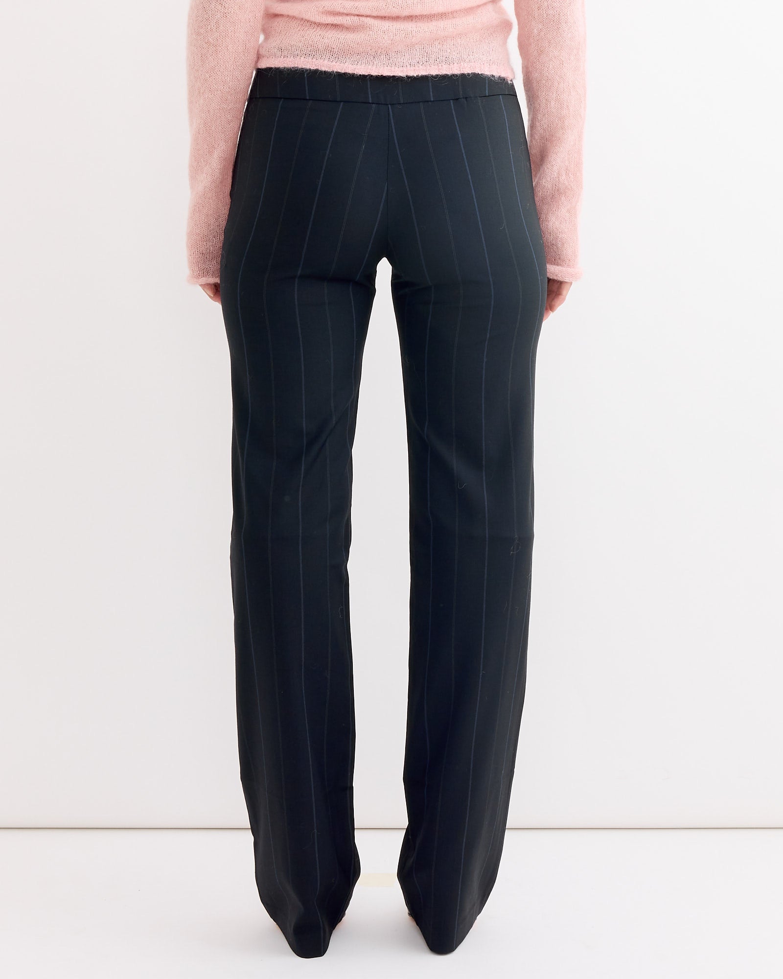 A person wearing the Saba Pant in Blue by Paloma Wool, featuring a low-rise silhouette.