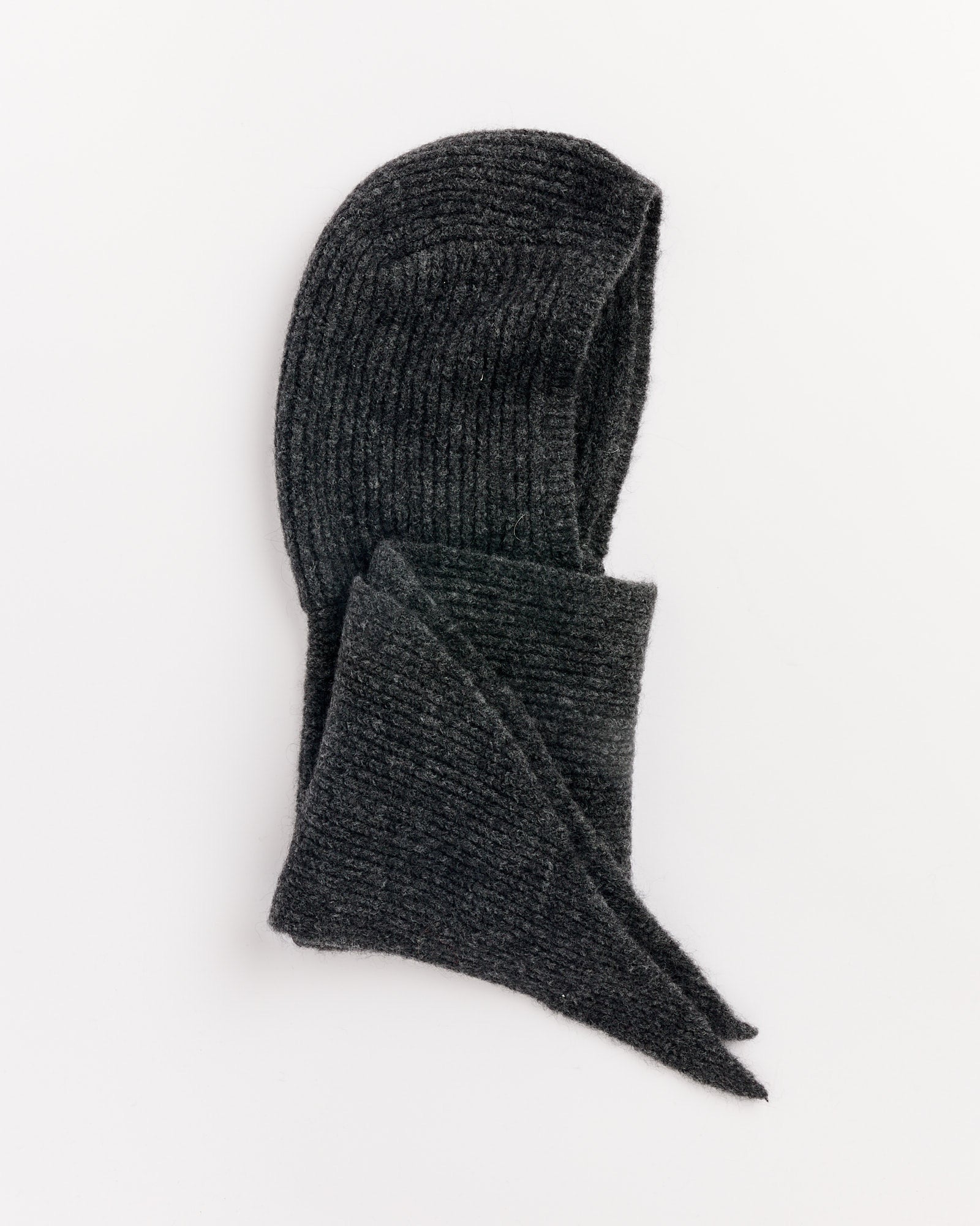 The Paloma Wool Coucou Bonnet in Dark Grey, crafted from mulesing-free wool, showcases a ribbed knit hooded scarf laid flat on a white background, with the bonnet-style hood at the top and scarf ends crossing below.
