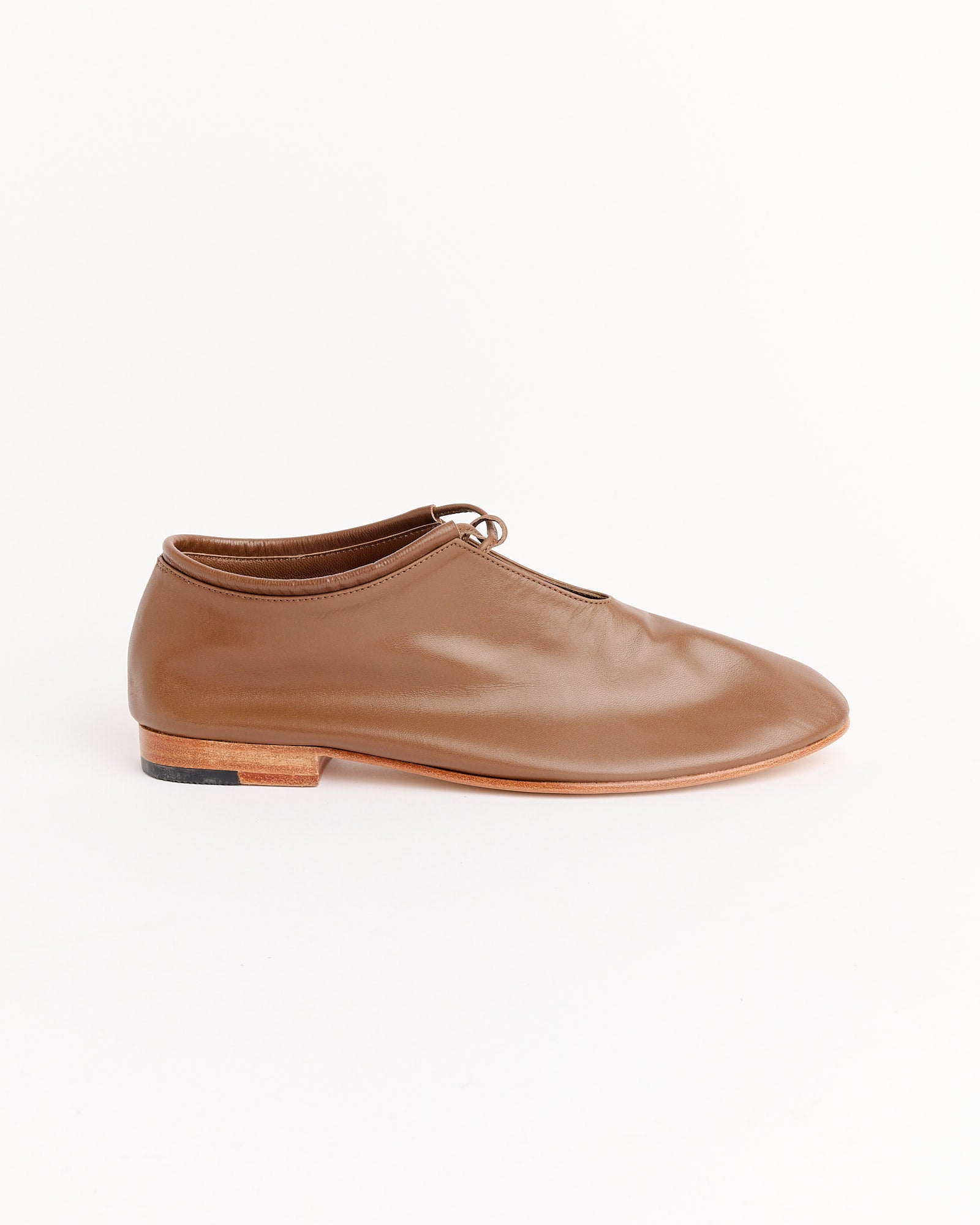 The Bootie in Vision by Martiniano, a brown lace-up handcrafted kid leather bootie with a low wooden heel, is shown in side profile against a plain white background.